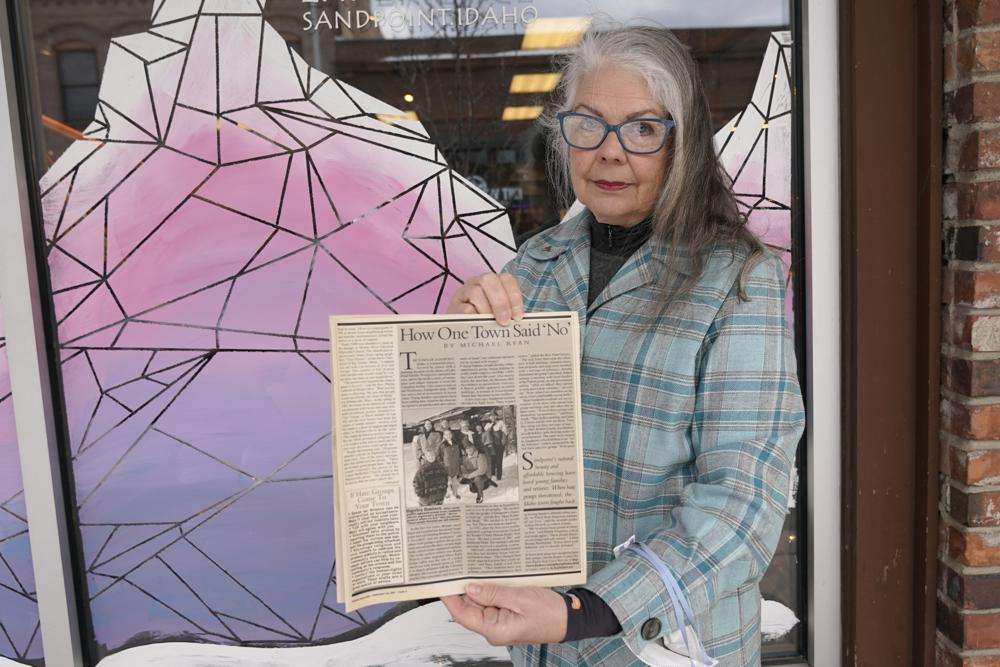 Linda Navarre, a member of the Bonner County Human Rights Task Force, poses for a photo Monday, Feb. 7, in downtown Sandpoint, Idaho, as she holds a 1997 issue of Parade Magazine that contains an article mentioning the efforts of herself and others fighting against conservative extremist groups in northern Idaho.