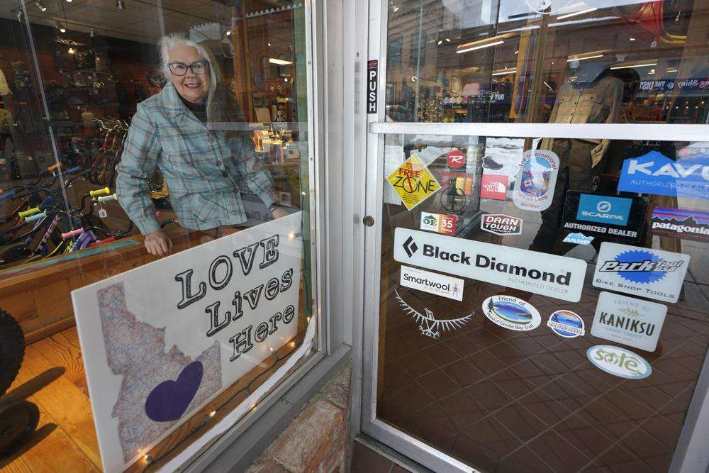 Linda Navarre, a member of the Bonner County Human Rights Task Force, poses for a photo Monday, Feb. 7 at an outdoor recreation store displaying a "Love Lives Here" sign in downtown Sandpoint, Idaho, that indicates all are welcome in the community regardless of race, gender, nationality, sexual orientation, or religion.