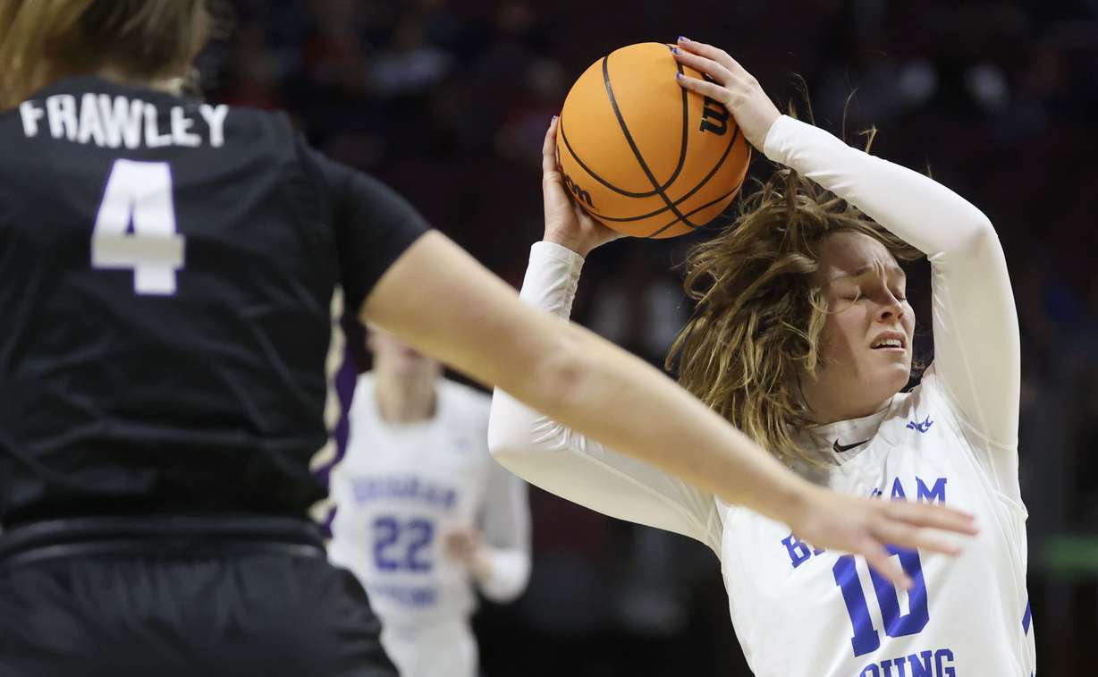 BYU guard Tegan Graham (10) grabs the ball as Portland forward Keeley Frawley (4) guards her in the 2022 WCC Women's Basketball Tournament semifinals at the Orleans Arena in Las Vegas on Monday, March 7, 2022. BYU won 59-52.