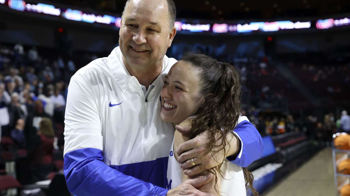 BYU Cougars women’s basketball coach Jeff Judkins hugs BYU Cougars guard Maria Albiero (5) after BYU beat the Portland Pilots in the 2022 WCC Women's Basketball Tournament semifinals at the Orleans Arena in Las Vegas on Monday, March 7, 2022. BYU won 59-52.