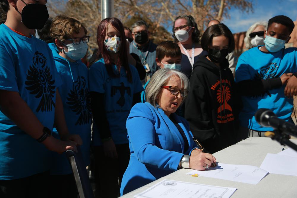 Gov. Michelle Lujan Grisham signs one of a suite of education bills on Tuesday, March 1, 2022, in Santa Fe, New Mexico. For most New Mexico residents, college will now be officially tuition-free.