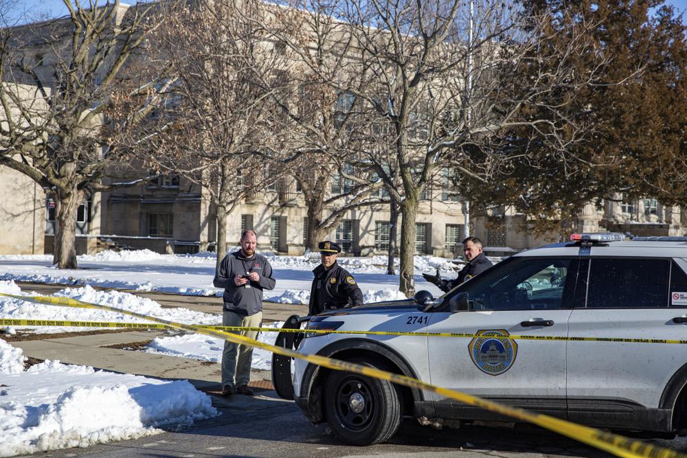Police investigate a shooting outside of East High School in in Des Moines, Iowa, on Monday.