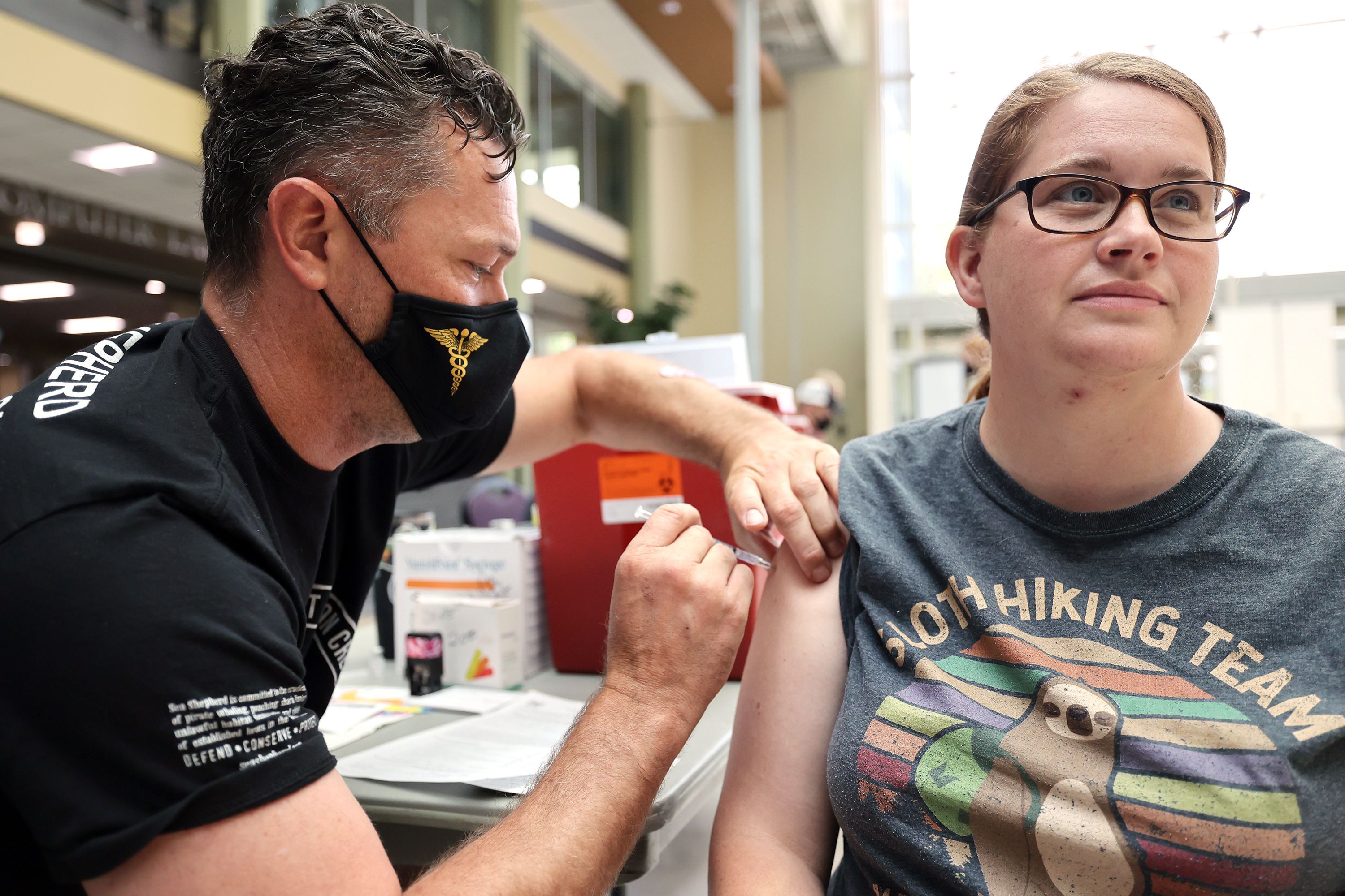 Raymond Searles, a nurse with the Utah Air National Guard, gives Kristi Rasmussen a COVID-19 vaccination at Weber State University in Ogden on Aug. 10, 2021. The Department of Education announced Monday that it had extended nearly a half-billion dollars in funding over the past year to Utah colleges and universities under the American Rescue Plan.