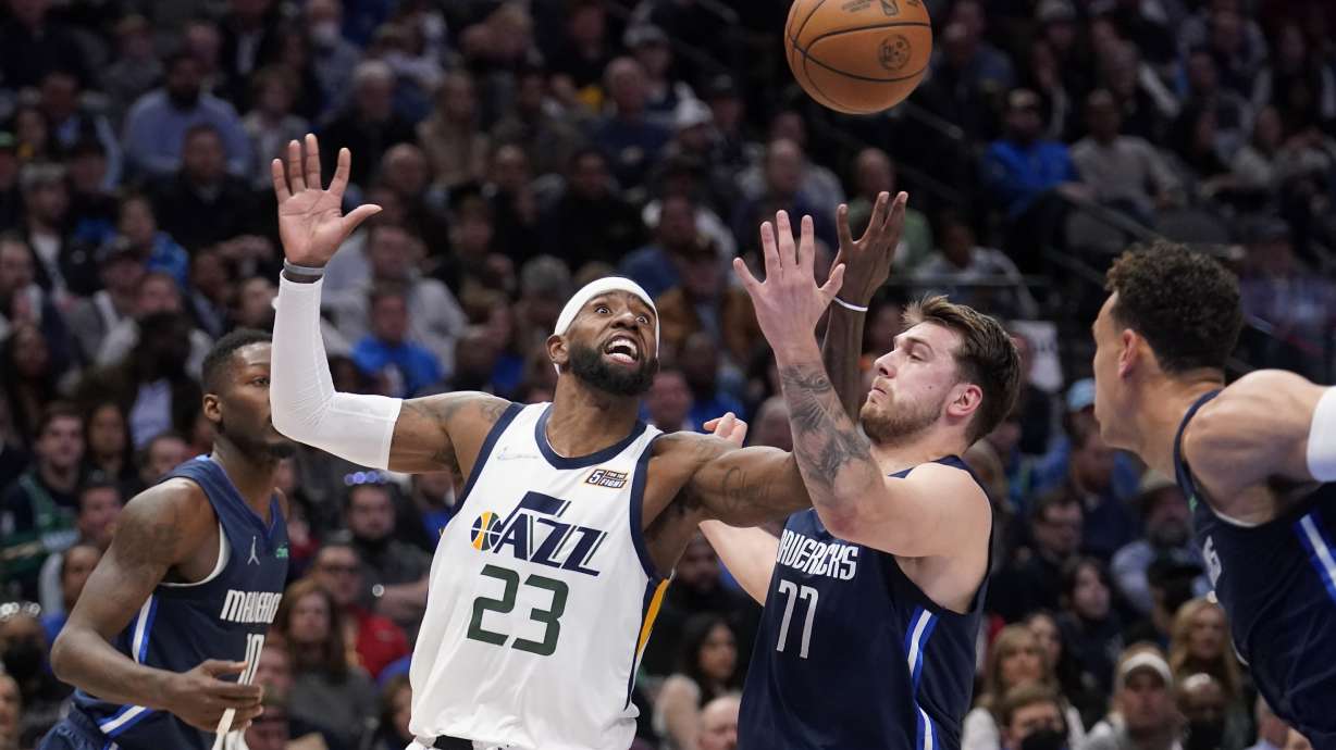 Utah Jazz forward Royce O'Neale (23) loses control of the ball as Dallas Mavericks forward Dorian Finney-Smith, left, and guard Luka Doncic (77) defend in the first half of an NBA basketball game in Dallas, Monday, March, 7, 2022.