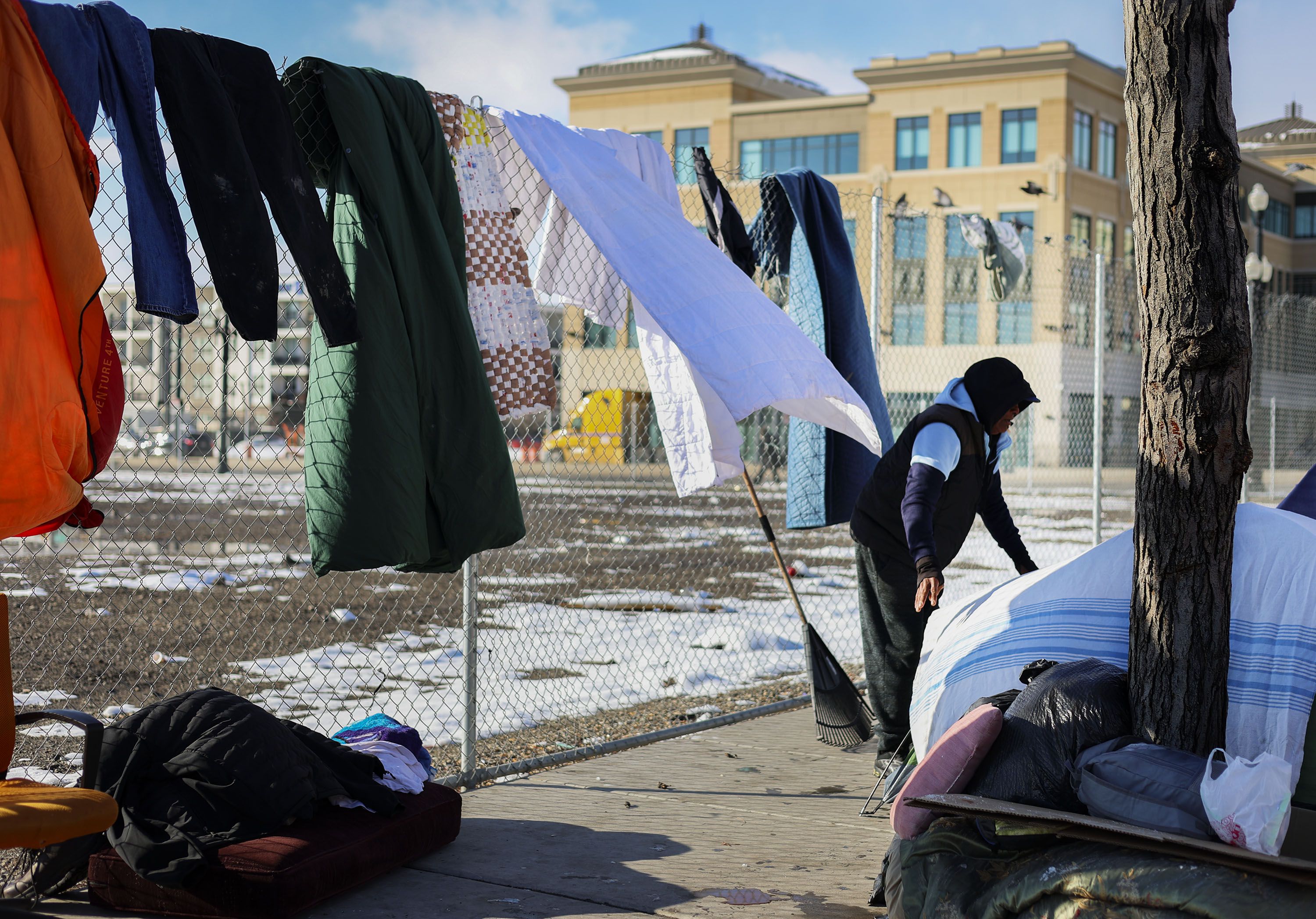 Martin, no last name given, dries his clothing and blankets at his camp on Rio Grande Street in Salt Lake City on Monday. Martin has been living on the street for five months. As soon as the winter ends he will resume his job as a seed picker.