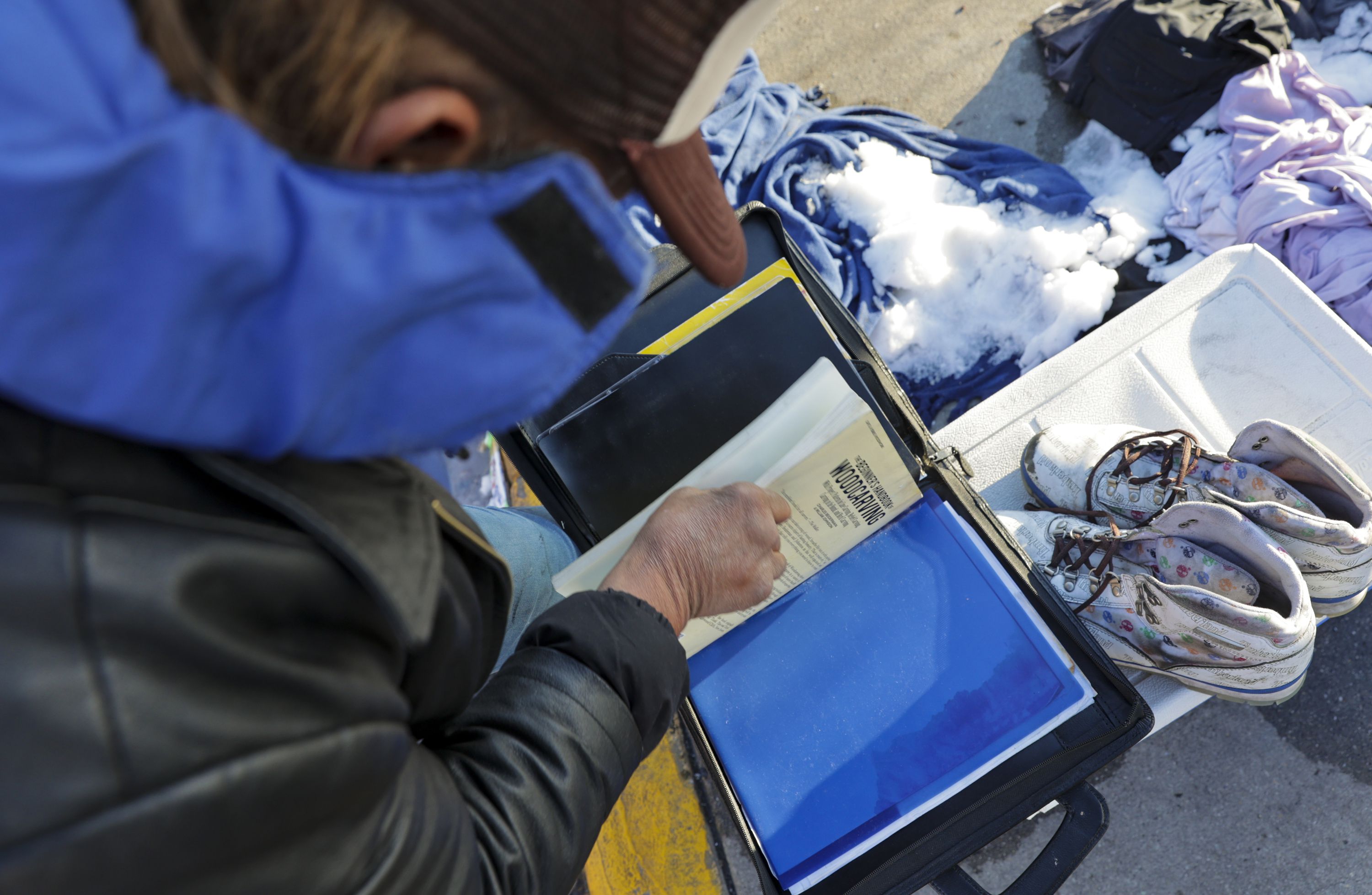 Jose Alejandro Vargas Nocelo goes through his documents outside of the Weigand Homeless Resource Center in Salt Lake City on Monday. Though the Utah Legislature gave a record-breaking $70 million this year to fight affordable housing shortages and homelessness, advocates said the sum fell short of what they hoped for.