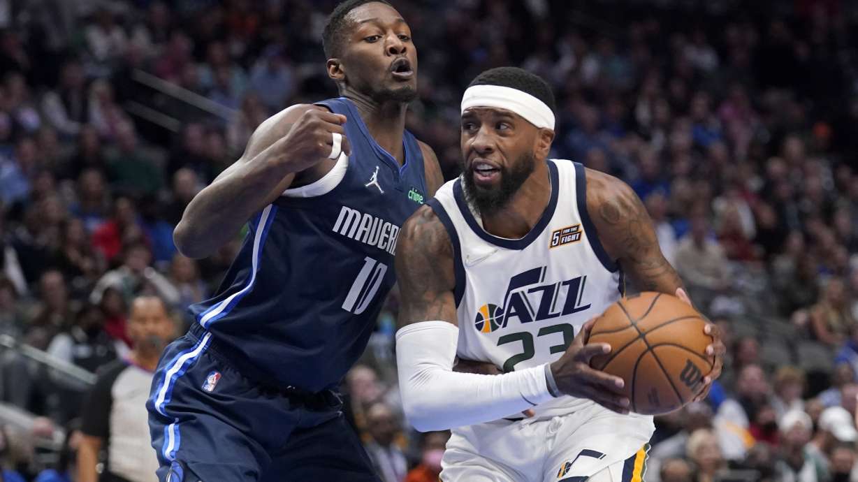 Dallas Mavericks forward Dorian Finney-Smith (10) defends as Utah Jazz forward Royce O'Neale (23) works to the basket in the first half of an NBA basketball game in Dallas.