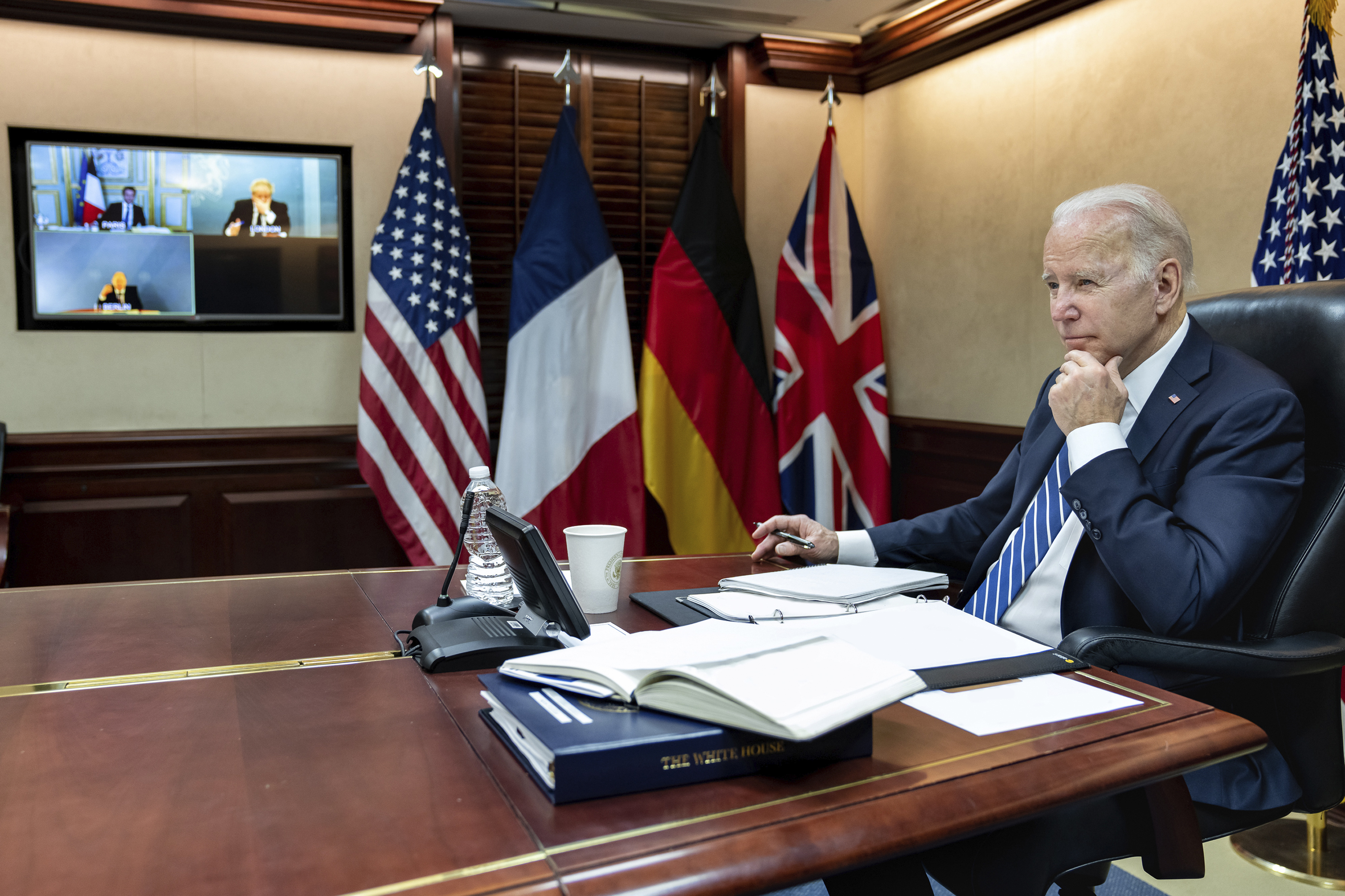 In this image provided by the White House, President Joe Biden listens during a secure video call with French President Emmanuel Macron, German Chancellor Olaf Scholz and British Prime Minister Boris Johnson in the Situation Room at the White House Monday, in Washington.