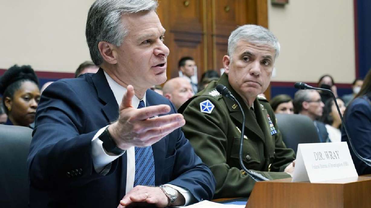 FBI Director Christopher Wray, left, testifies on Capitol Hill in Washington, Tuesday, during a hearing on worldwide threats. Seated next to Wray is National Security Agency Director Gen. Paul Nakasone, right. U.S. intelligence believes Russia underestimated the strength of Ukraine's resistance before launching an invasion that has likely caused thousands of Russian casualties.