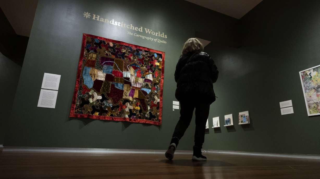 Nancy Rigby looks at “Map Quilt,” by an unidentified artist, at “Handstitched Worlds: The Cartography of Quilts” at the Utah Museum of Fine Arts at the University of Utah in Salt Lake City on Tuesday.