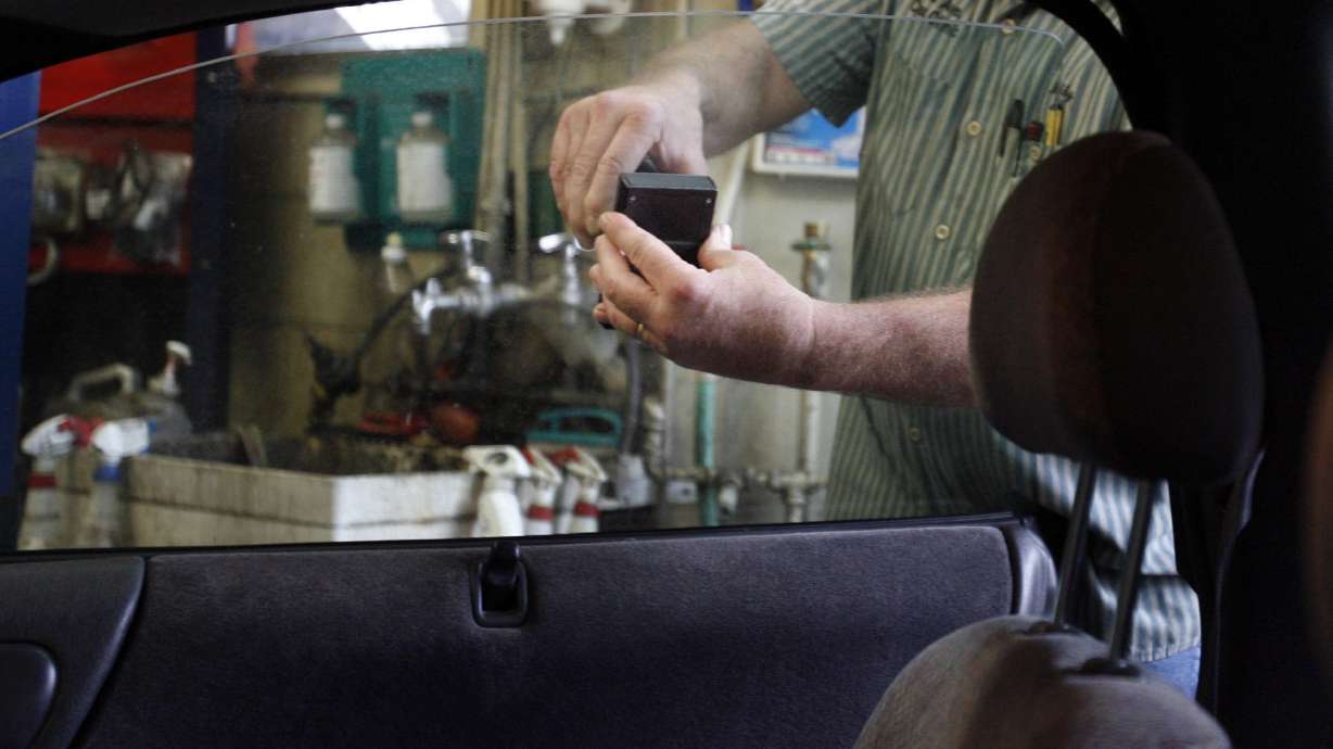 Bobby Rose uses a light transmittance meter to check the tint of a vehicle's windows during a safety inspection at the 3rd Avenue Car Clinic in Salt Lake City on Feb. 9, 2012. The Utah Legislature passed a bill this past session that changes the visible light transmission rate in Utah's vehicle windows.