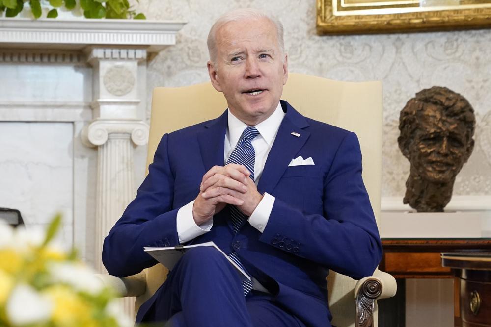 President Joe Biden sits in the Oval Office of the White House on Friday in Washington.