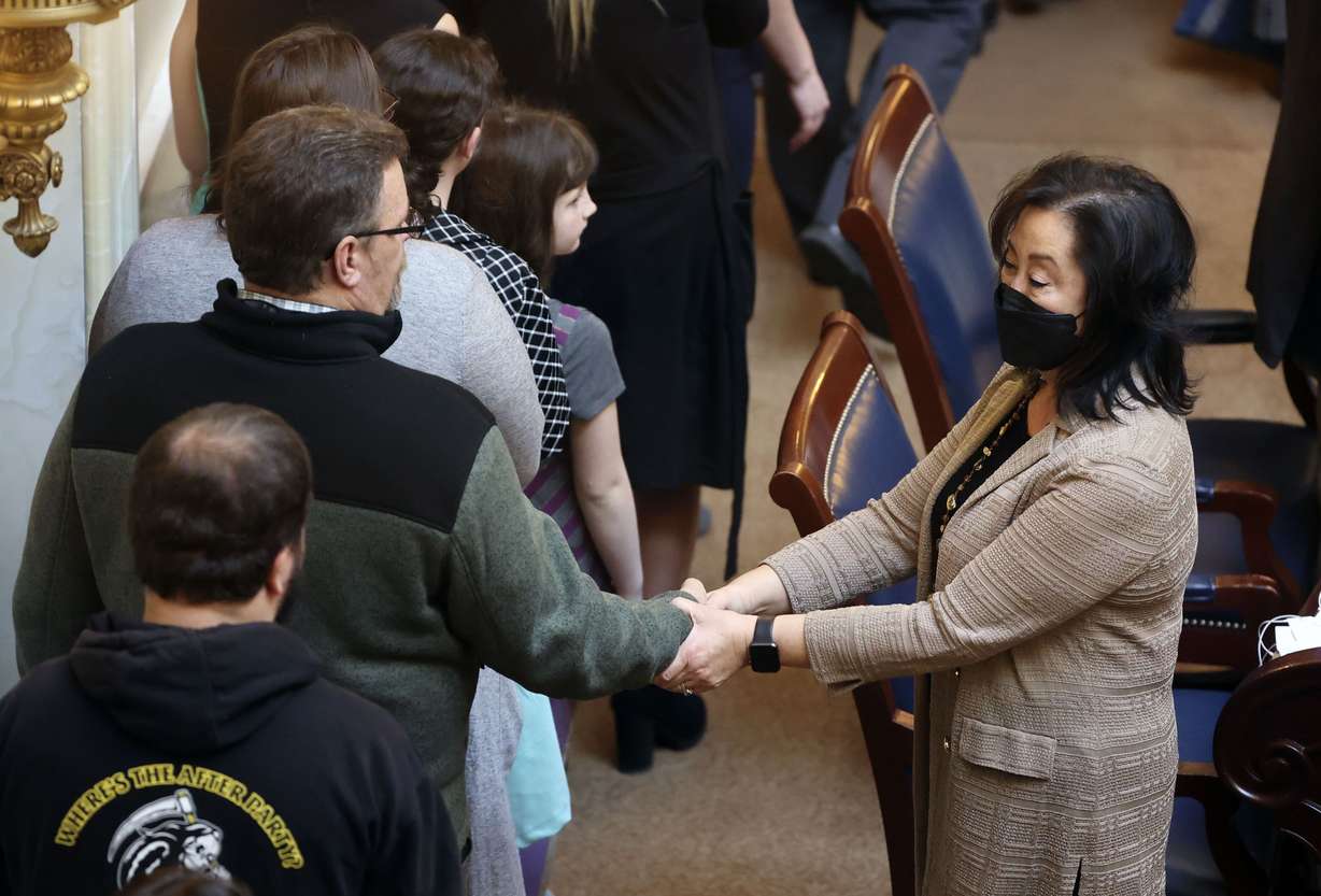 Sen. Jani Iwamoto, D-Holladay, right, shakes hands with families of fallen Utah military members as the Senate honors them in the Senate chamber at the Capitol in Salt Lake City on Feb. 11.