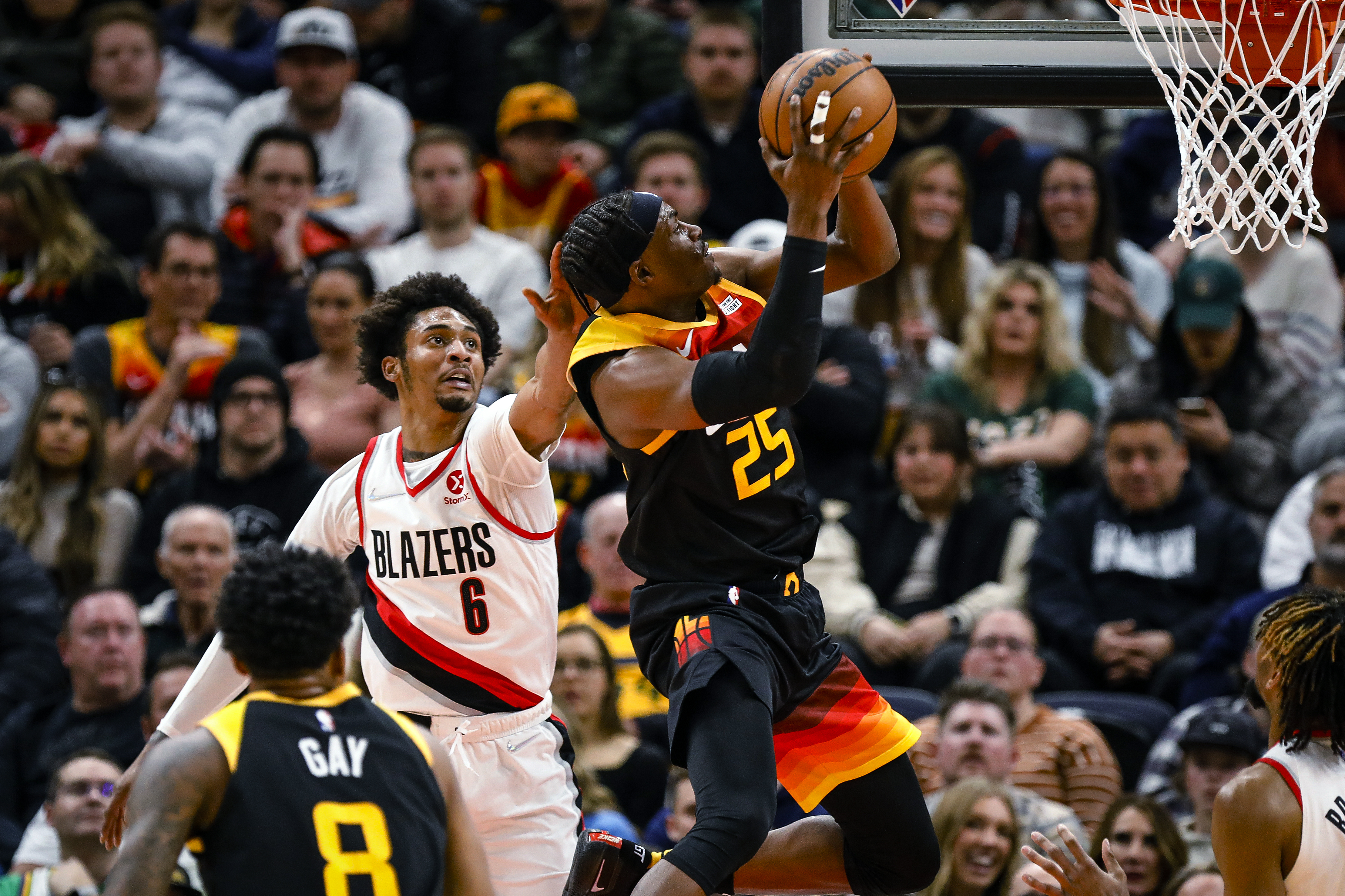 Utah Jazz forward Danuel House Jr. (25) switches hands to get around the defense of Portland Trail Blazers guard Keon Johnson (6) during the first half of an NBA basketball game Wednesday, March 9, 2022, in Salt Lake City.