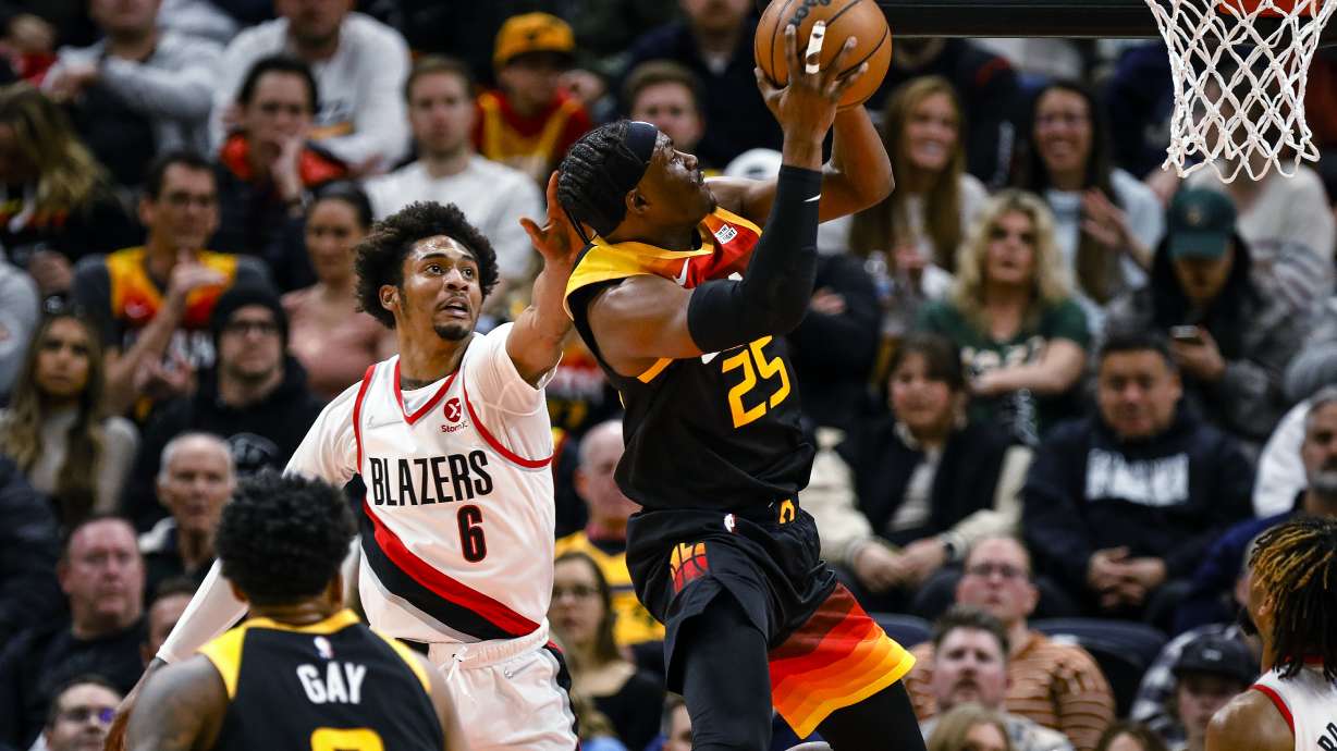 Utah Jazz forward Danuel House Jr. (25) switches hands to get around the defense of Portland Trail Blazers guard Keon Johnson (6) during the first half of an NBA basketball game Wednesday, March 9, 2022, in Salt Lake City.