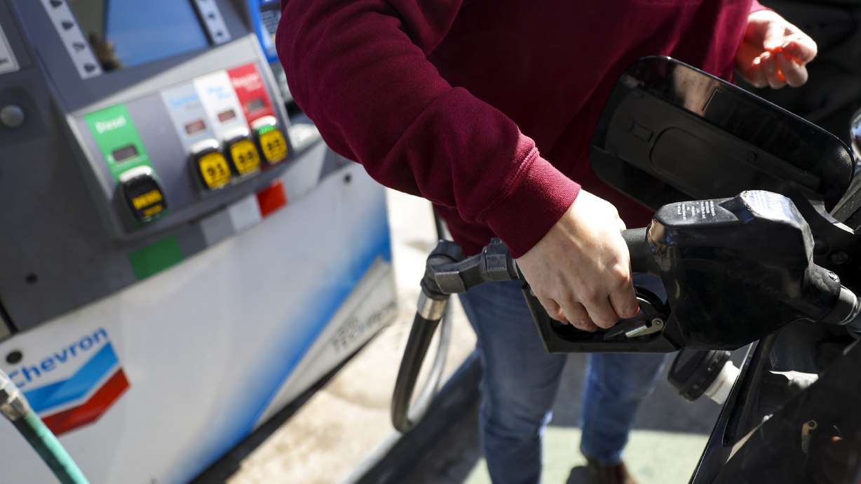 A driver pumps gas at a Chevron in Salt Lake City on Monday. The average price of gas in the U.S. broke the $4 per gallon line over the weekend for the first time since 2008.