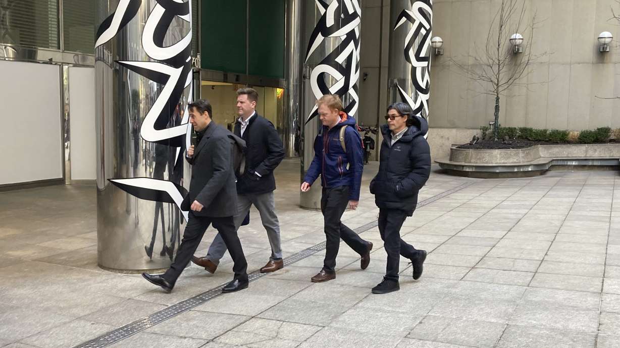 Major League Baseball Deputy Commissioner Dan Halem, left, Senior Vice President Patrick Houlihan, second from left, Executive Vice President Morgan Sword, second from right, and spokesman Glen Caplin arrive at the Major League Baseball Players Association in New York for labor negotiations, Tuesday March 8, 2022.