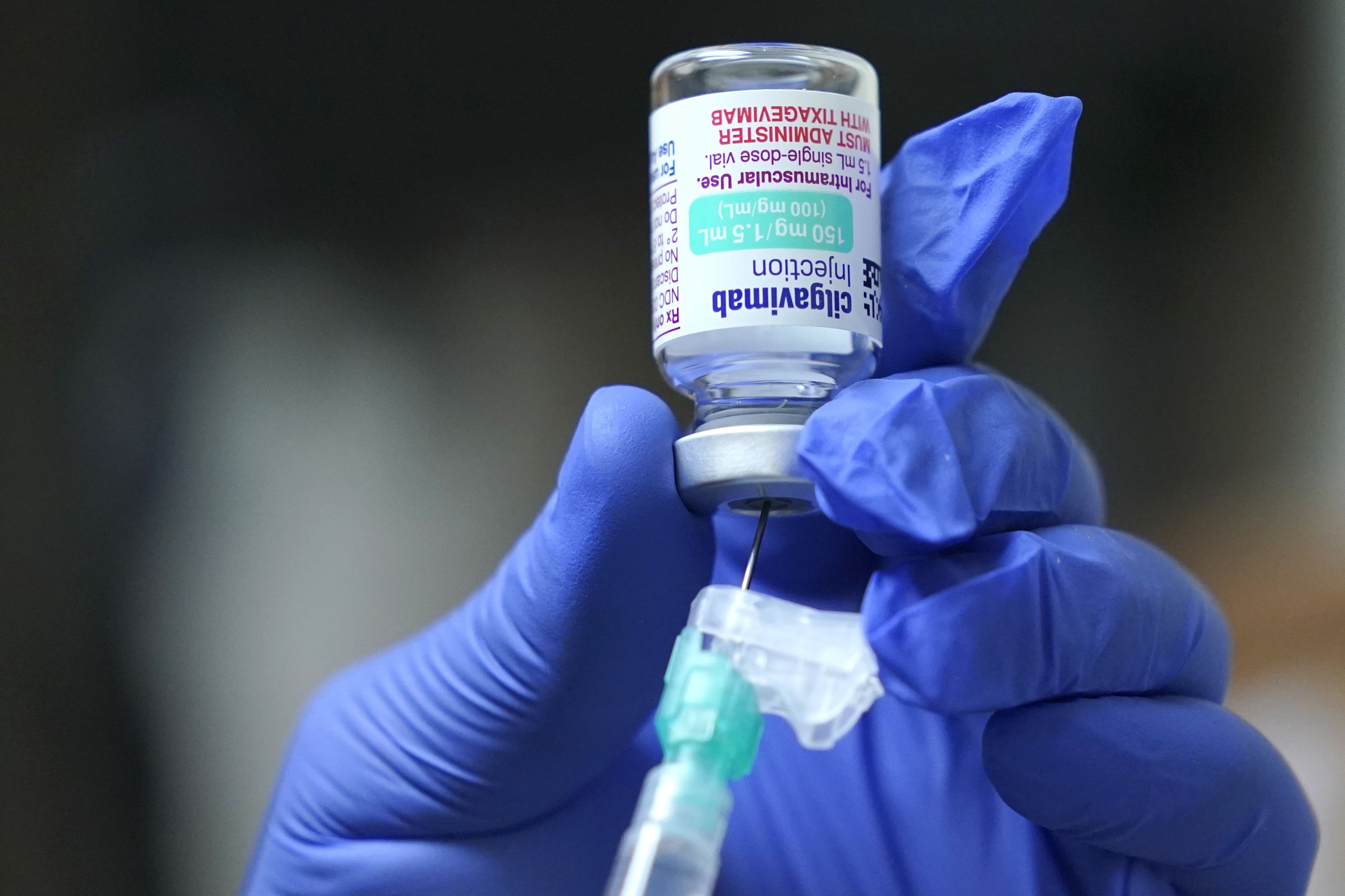 Jose Lazaro, a medical assistant at a University of Washington Medicine clinic, prepares a two-shot dose of AstraZeneca’s Evusheld, the first set of antibodies grown in a lab to prevent COVID-19, Jan. 20, in Seattle.