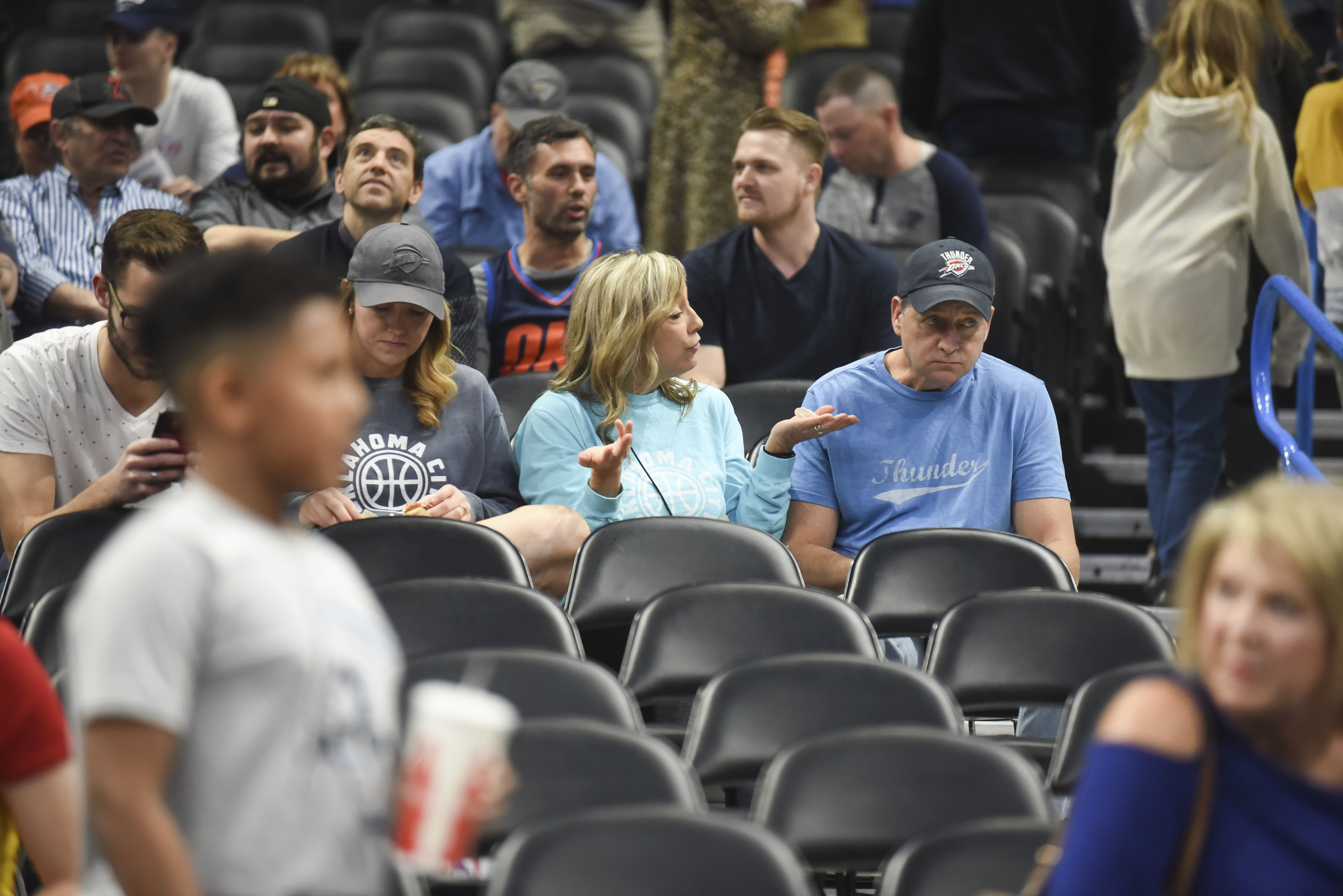 Fans react after it is announced that an NBA basketball game between Oklahoma City Thunder and Utah Jazz in Oklahoma City has been postponed on Wednesday, March 11, 2020, after Rudy Gobert became the first NBA player to test positive for COVID-19.