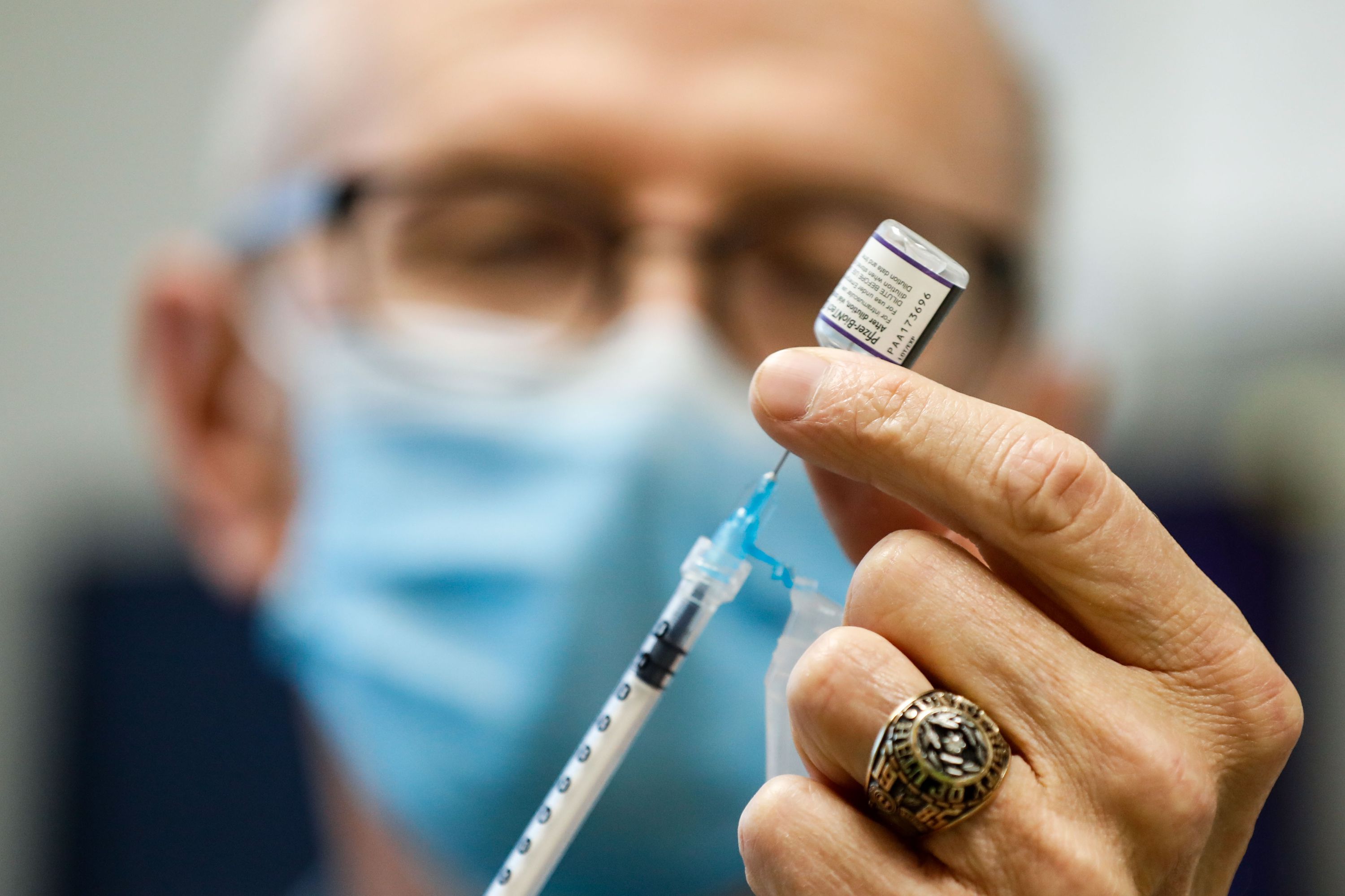 Nurse Jon Hight draws a Pfizer-BioNTech COVID-19 vaccine into a syringe at the Salt Lake Public Health Center on Sept. 30, 2021.