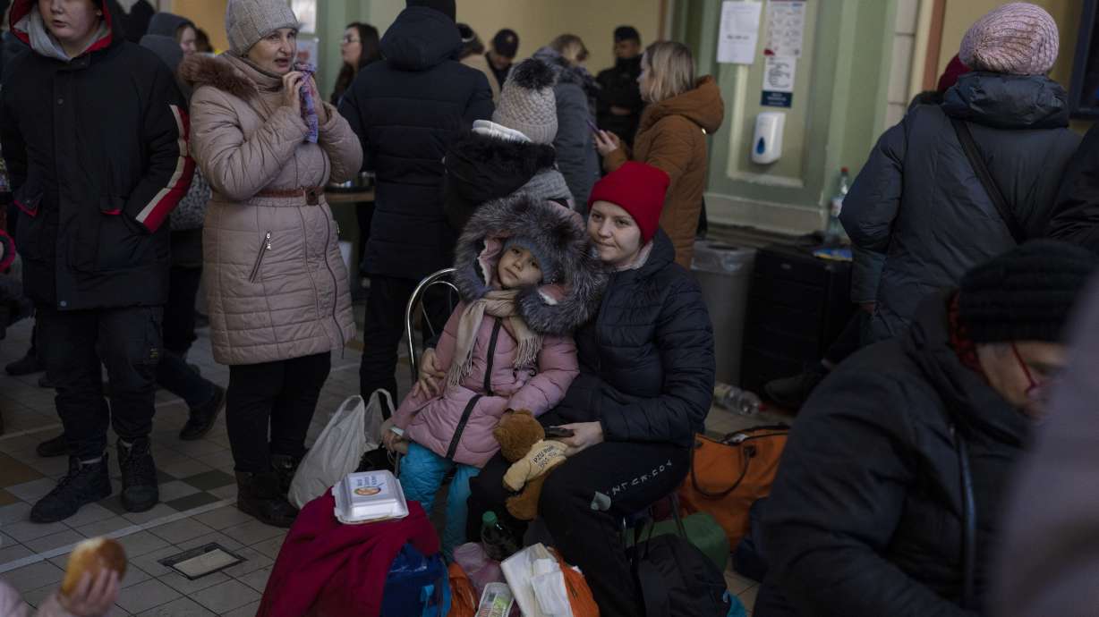 Ukrainian refugees wait at Przemysl train station, southeastern Poland, on Friday. Thousands of people have been killed and more than 2.3 million have fled the country since Russian troops crossed into Ukraine on Feb. 24.