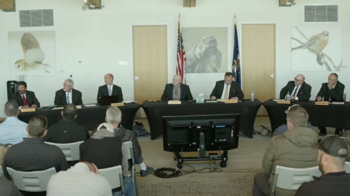 Members of the Utah Wildlife Board discuss their original vote for a season ban of trail cameras for hunting purposes during a meeting at the Eccles Wildlife Education Center in Farmington Thursday. The board voted to uphold its original decision made in January.