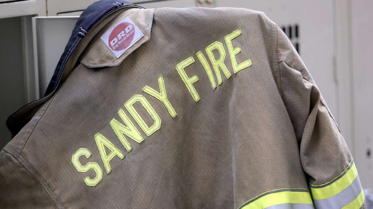 A Sandy fire captain was arrested Thursday and accused of possessing child pornography and hiding cameras in a home tanning and salon business where teenage girls undressed.