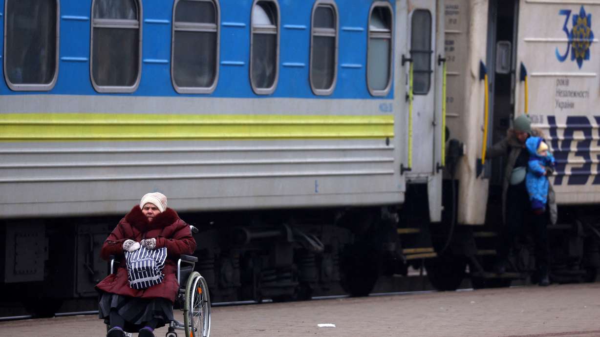 A person in a wheelchair waits for transfer after fleeing the ongoing Russian invasion at the main train station in Lviv, Ukraine, March 5. More of Ukraine's 2.7 million people suffering disabilities will die or be seriously wounded as the war continues and they struggle to evacuate, an activist says.