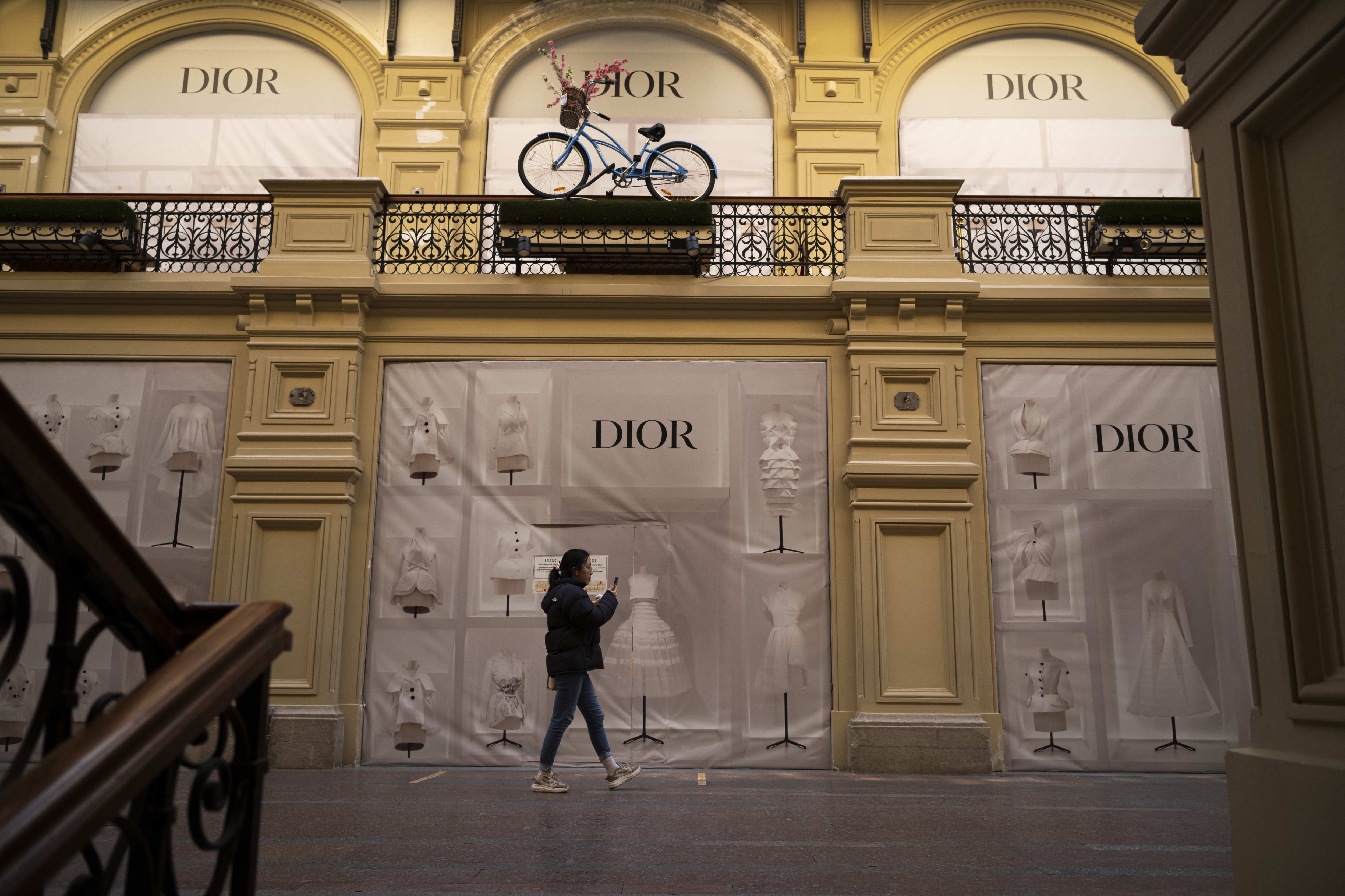 A visitor walks past a closed Dior boutique inside the GUM department store in Moscow, Russia, Wednesday.