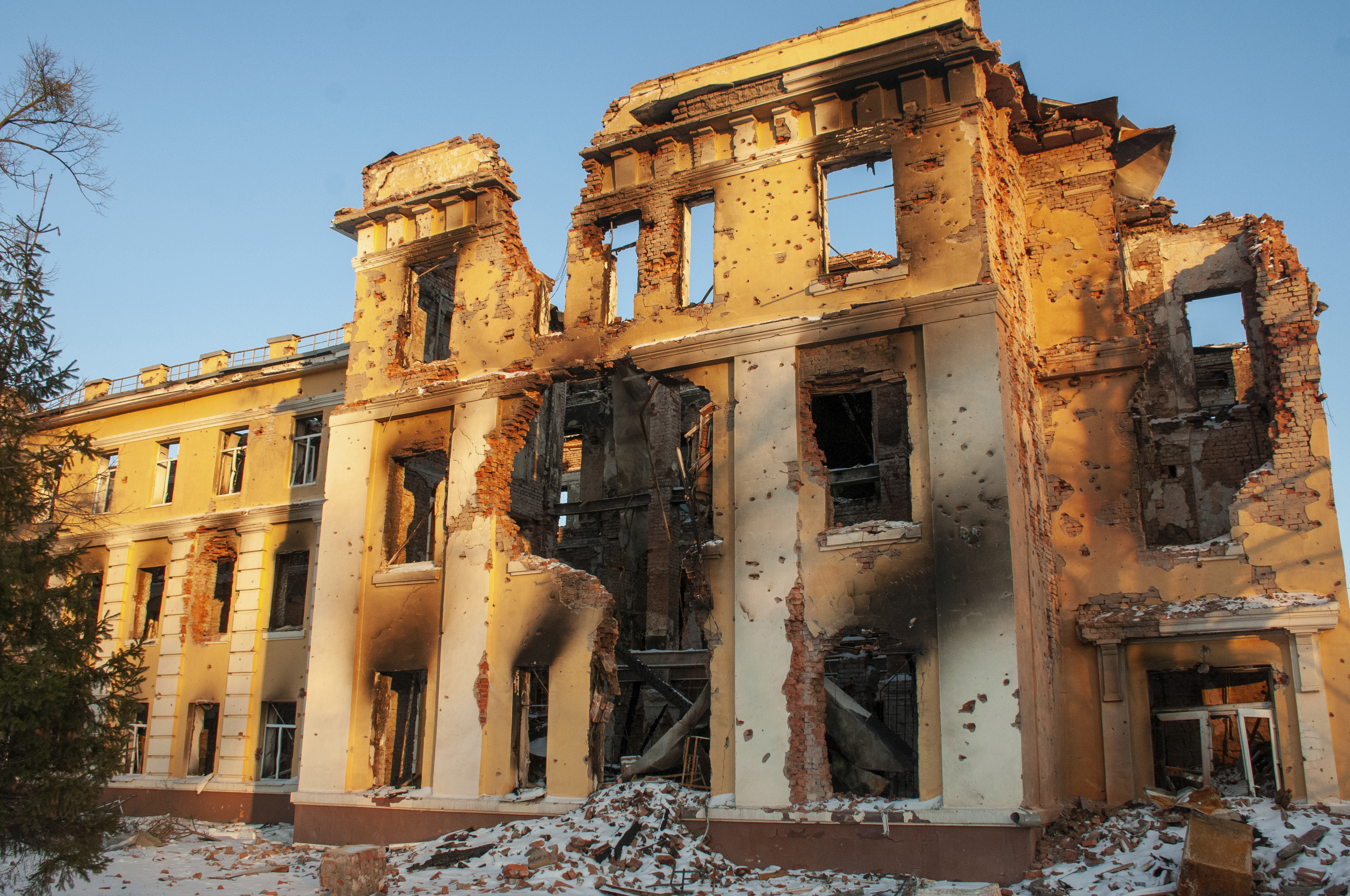 A damaged by shelling building is lit by sunset in Kharkiv, Ukraine, Friday.