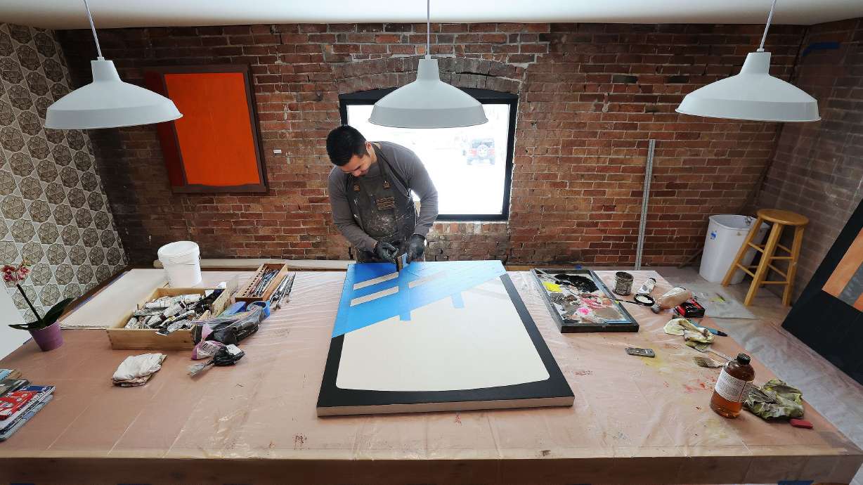 Artist-in-residence Kheng Lim works on a project at Modern West Fine Art in Salt Lake City on Wednesday.