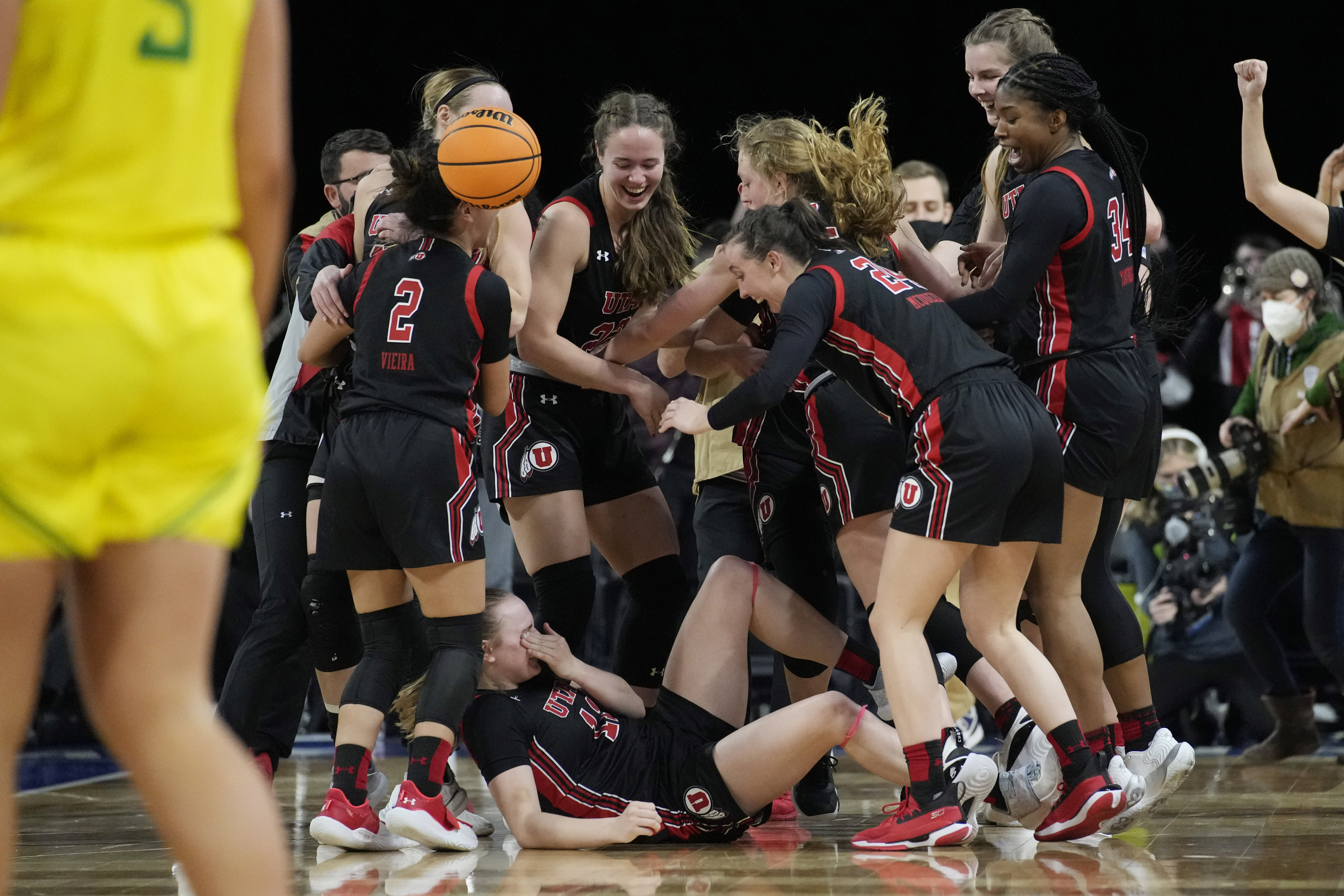 Utah players celebrate after defeating Oregon in an NCAA college basketball game in the semifinal round of the Pac-12 women's tournament Friday, March 4, 2022, in Las Vegas.