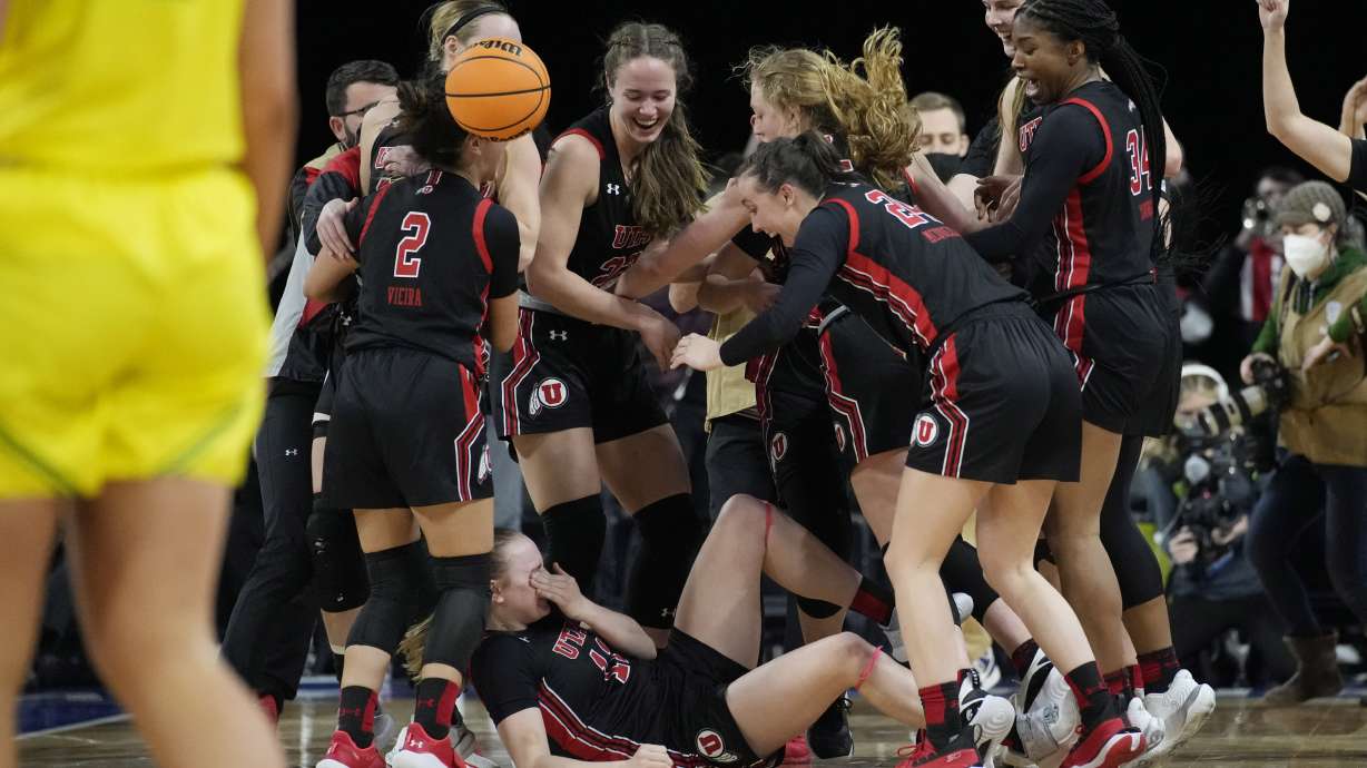 Utah players celebrate after defeating Oregon in an NCAA college basketball game in the semifinal round of the Pac-12 women's tournament Friday, March 4, 2022, in Las Vegas.