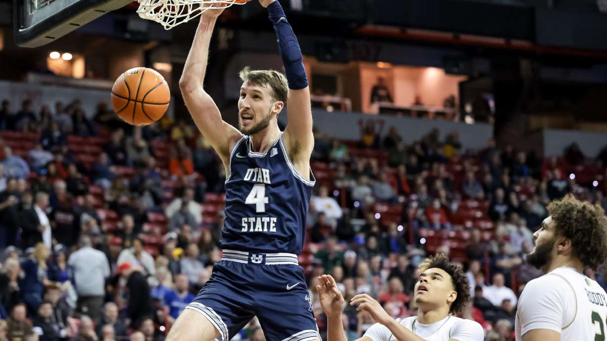 Utah State Aggies forward Brandon Horvath (4) dunks during a Mountain West tournament quarterfinal against the Colorado State Rams at the Thomas & Mack Center in Las Vegas on Thursday, March 10, 2022.