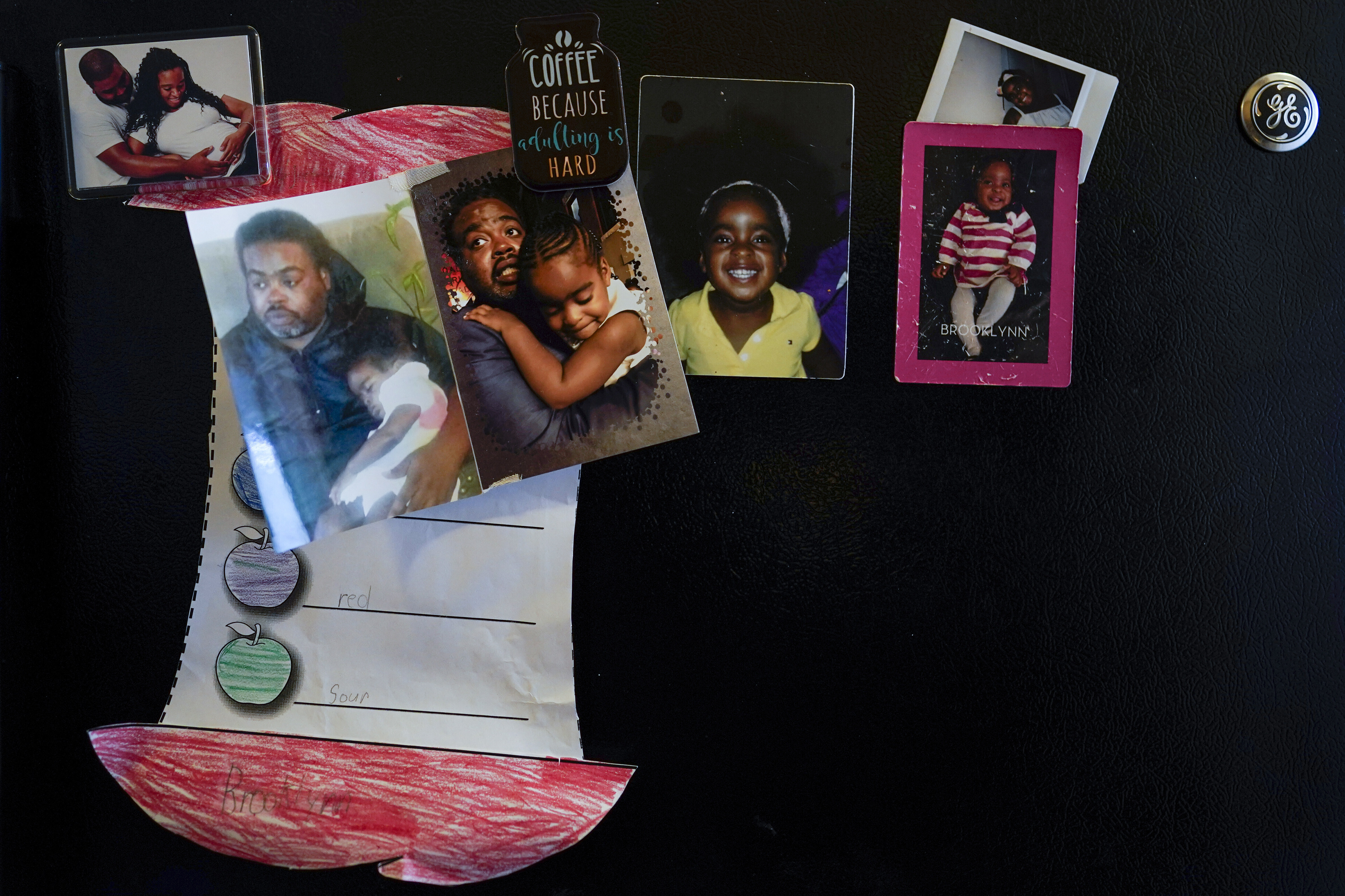 Family photos of Danielle and Rodney Chiles and their daughter, Brooklynn, decorate the kitchen refrigerator in Washington, Feb. 9. Rodney died of COVID-19 last year and Brooklyn has tested positive three times. Brooklynn is part of a NIH-funded multi-year study at Children's National Hospital to look at impacts of COVID-19 on children's physical health and quality of life.
