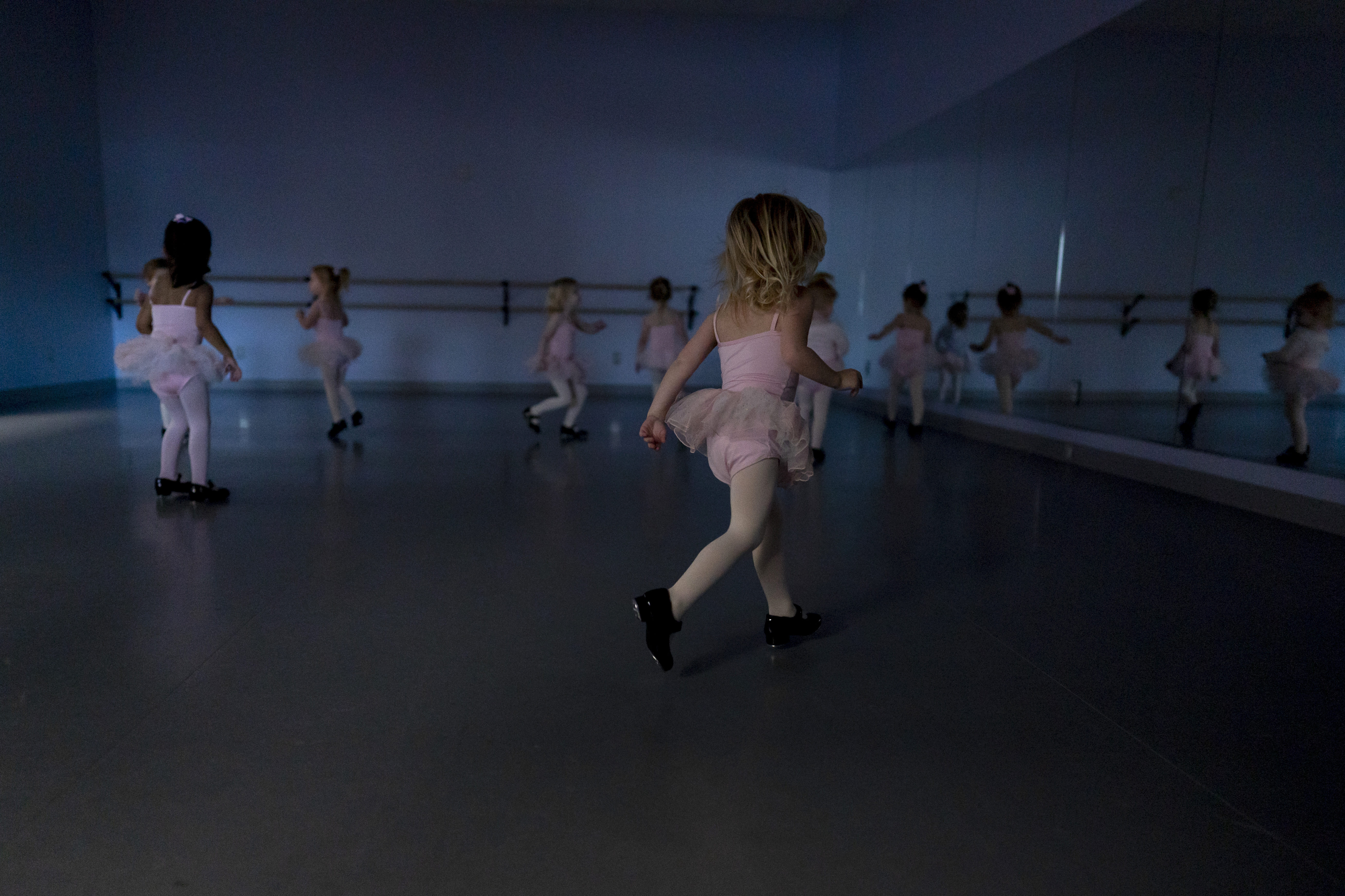 Alyssa Carpenter, 2, runs around in tap shoes during "Dance Part" at Tiny Tot ballet and tap class at Lyrique Dance in Warrenton, Va., Jan. 15. Alyssa has had COVID-19 twice and suffers long-term symptoms.