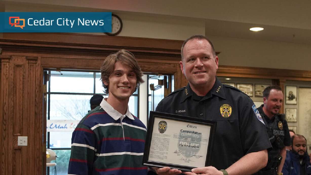 The Cedar City Police Department's Chief of Police, Darin Adams, awards Colter Bennett a citizen commendation in Cedar City, Wednesday.