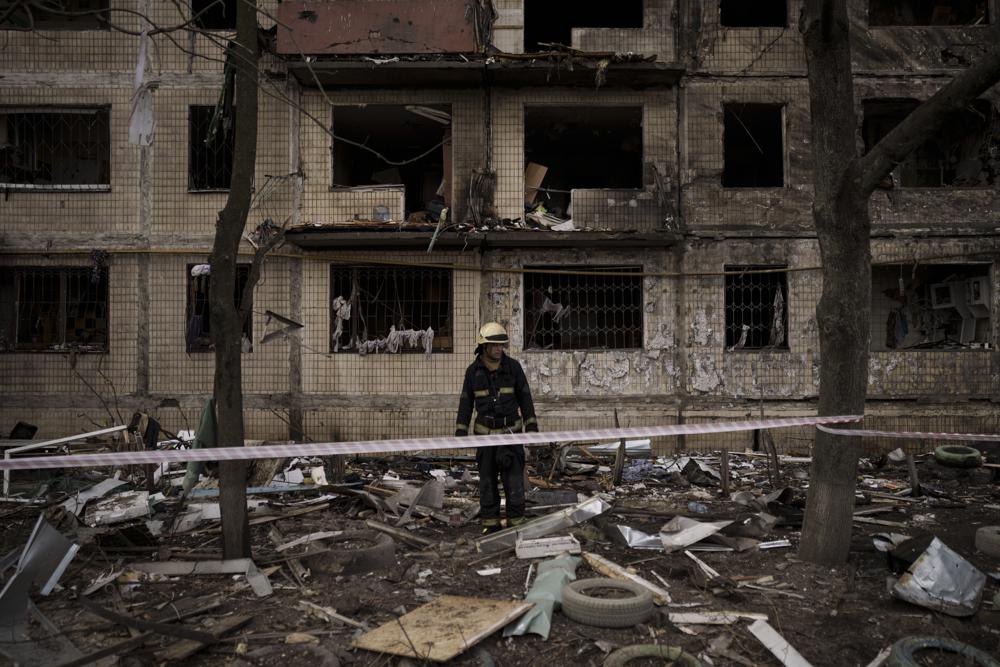 A Ukrainian firefighter walks outside a destroyed building after it was hit by artillery shelling in Kyiv in Kyiv, Ukraine, Monday. Russia and Ukraine kept a fragile diplomatic path open with a new round of talks on Monday even as Moscow’s forces pounded away at Kyiv and other cities across the country.