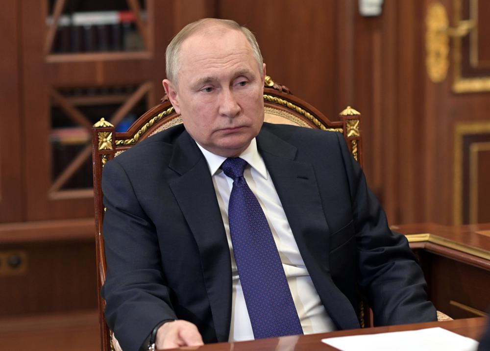 Russian President Vladimir Putin listens to St. Petersburg's Gov. Alexander Beglov during their meeting in the Kremlin in Moscow, on March 1. Russia has sent the clearest signal yet that it will soon default — the first time it will have failed to meet its foreign debt obligations since the Bolshevik revolution more than a century ago.