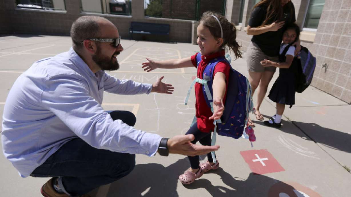 Chris Conard picks up his daughter Hazel Conard from kindergarten at Whittier Elementary School in Salt Lake City before dropping her off at Makiko’s Daycare Center in Murray on Thursday, Sept. 5, 2019.