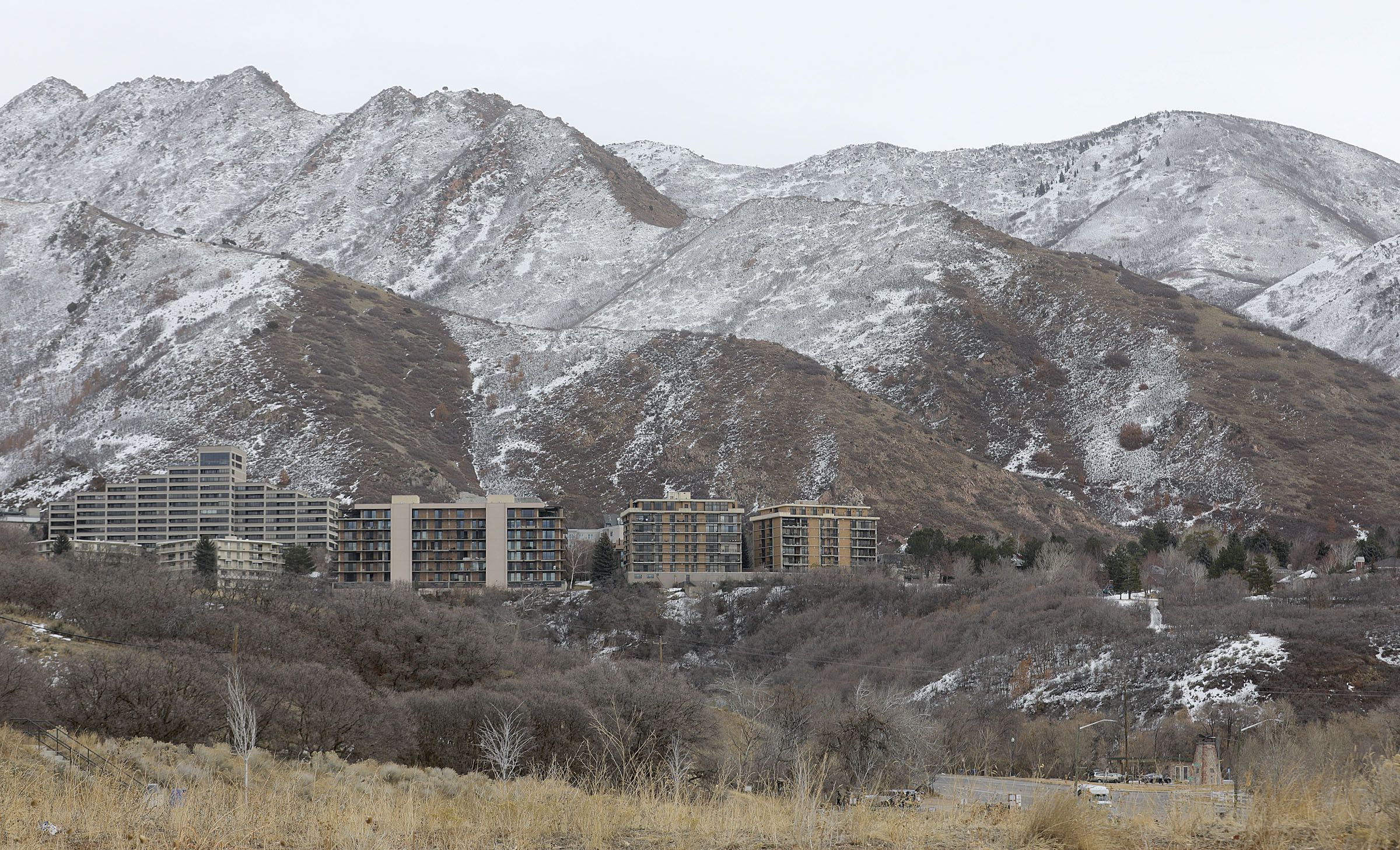 Snow dusts the foothills above Salt Lake City on Feb. 9, 2021. Rough projections 2022's put snowpack at 91% of average by April 1 — the typical end to the snowpack accumulation season — when water managers had desperately hoped for a banner year for snow.