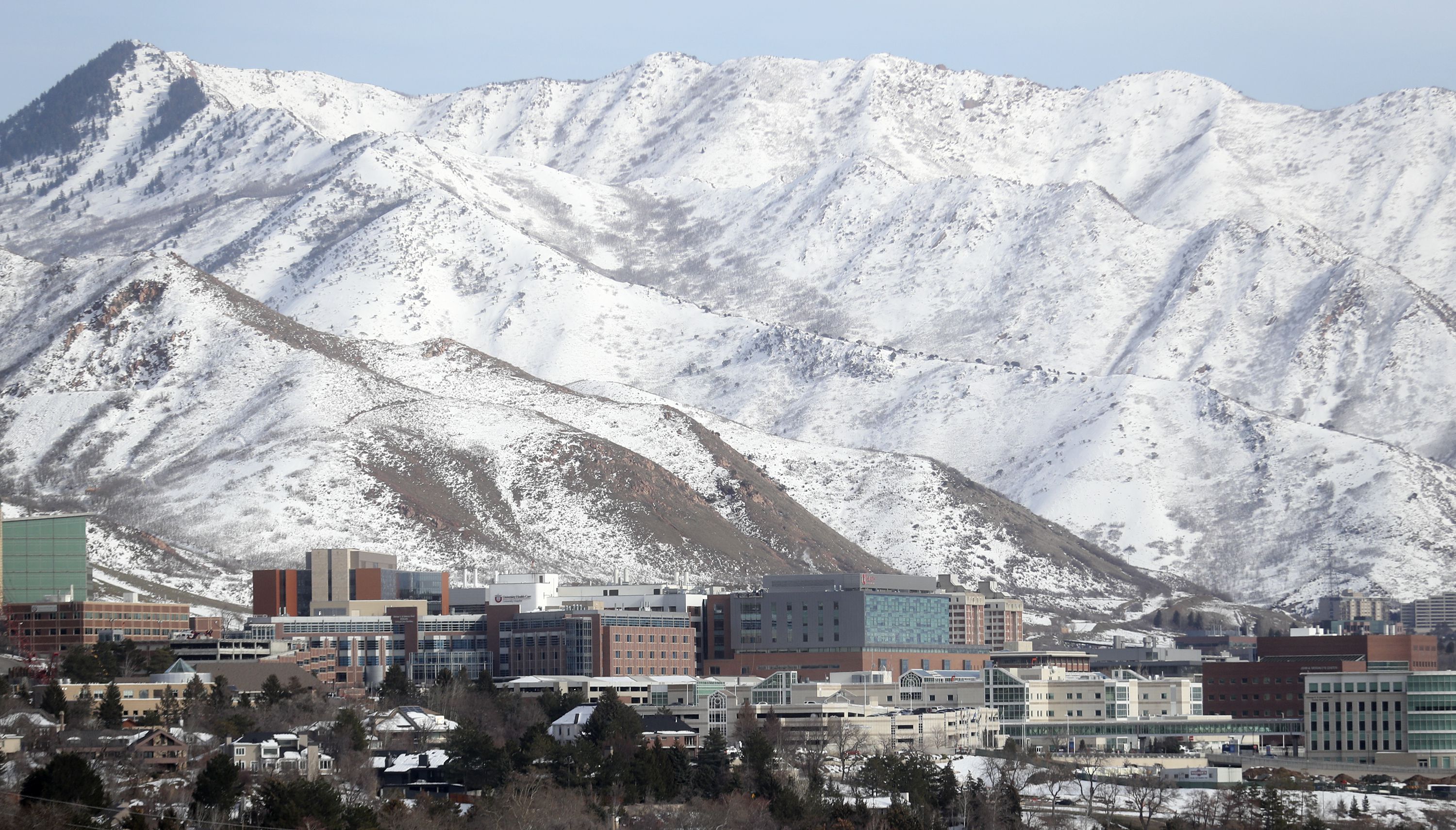 A thin snowpack covers the mountains behind the University of Utah on Monday. Utah’s snowpack is lower than normal this year.