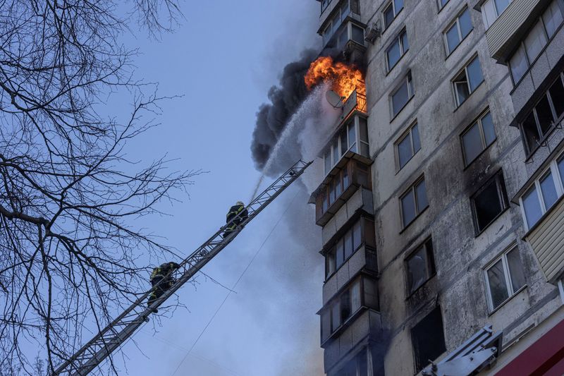 Firefighters work to put out a fire in a residential apartment building after it was hit by shelling in Kyiv, Ukraine, Tuesday.