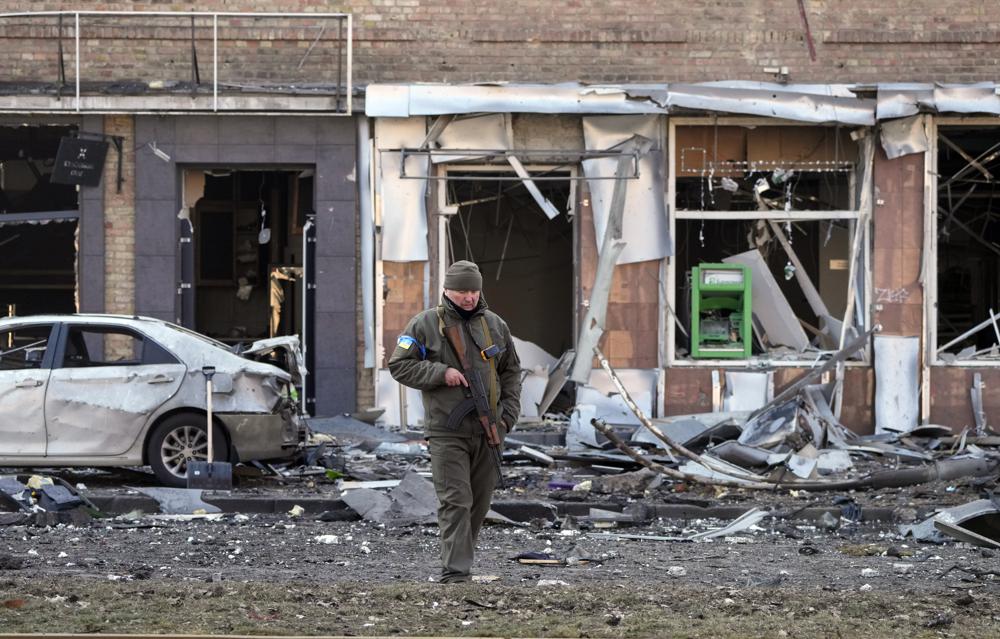 A Ukrainian soldier passes at a destroyed building after a Russian bombing attack in Kyiv, Ukraine, Monday. A longtime Fox News photojournalist was killed while reporting in Ukraine when a vehicle he was traveling in with correspondent Benjamin Hall came under fire.