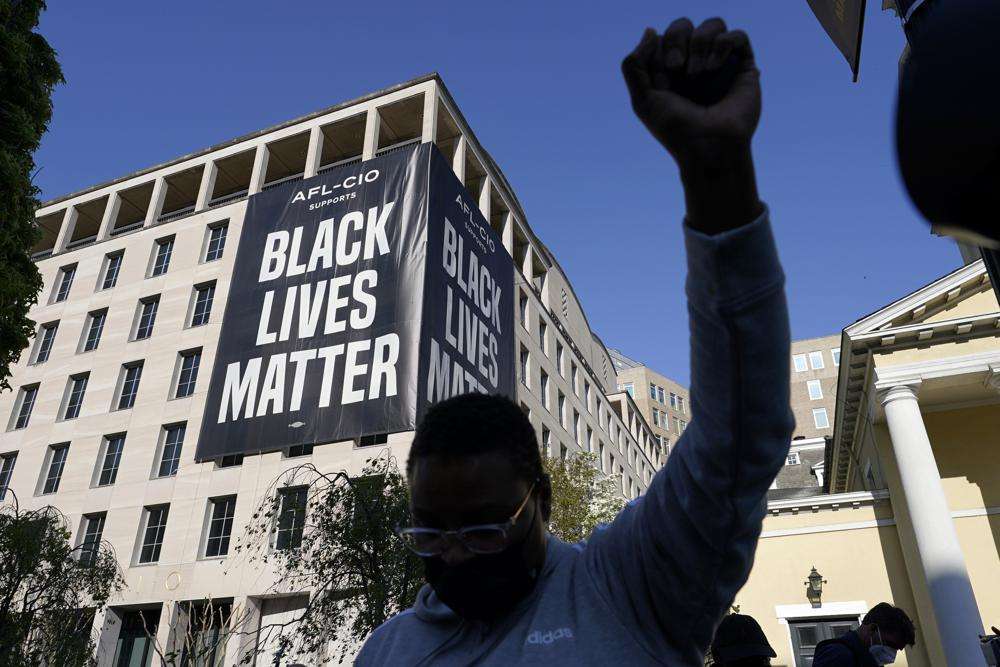 A person reacts on April 20, 2021, in Washington, at Black Lives Matter Plaza near the White House after the verdict in Minneapolis, in the murder trial against former Minneapolis police officer Derek Chauvin was announced. Few Americans believe there has been significant progress over the last 50 years in achieving equal treatment for Black people in dealings with police and the criminal justice system, a new poll says.