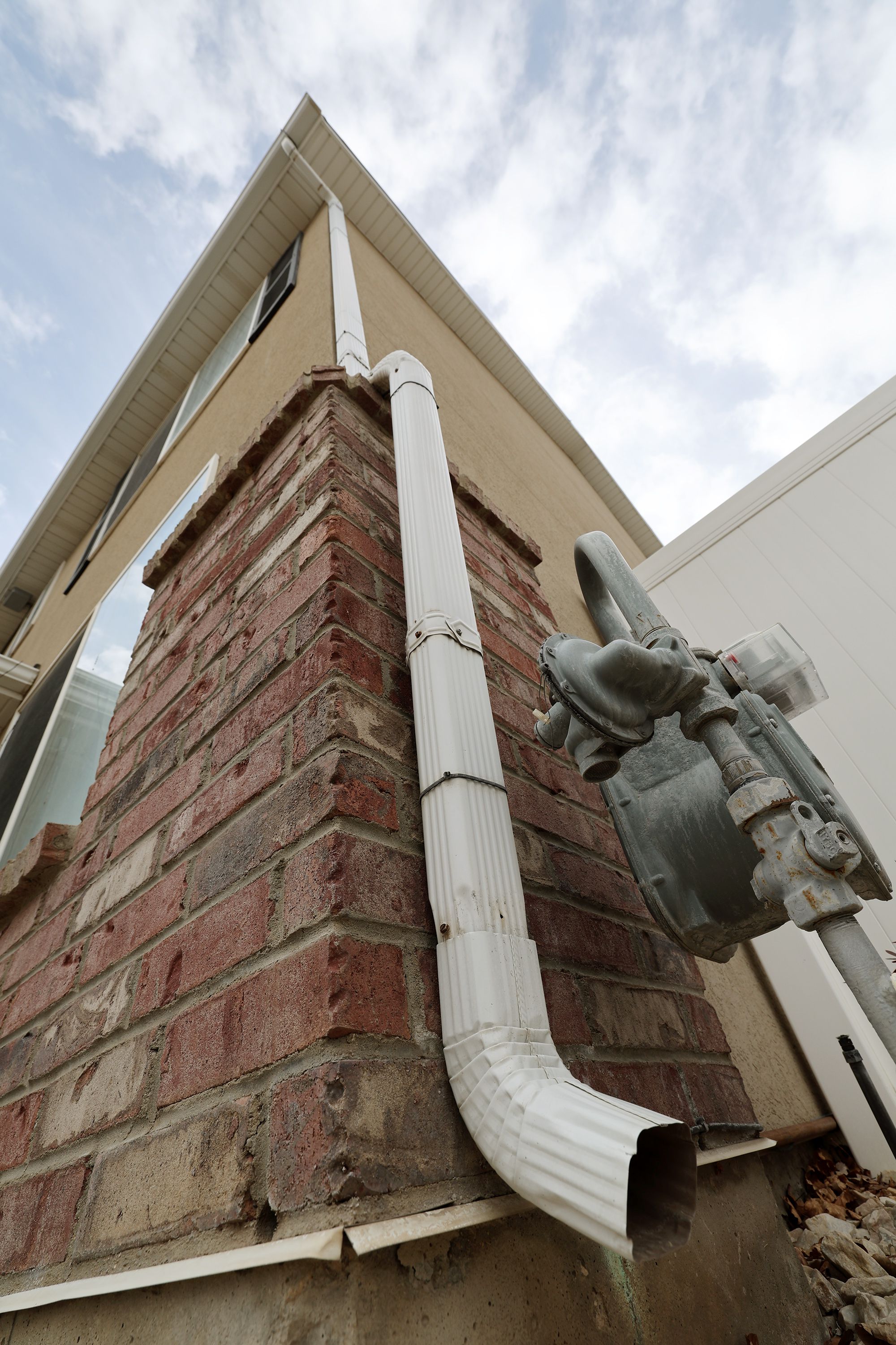 A rain gutter and downspout are pictured on a home in Herriman on Tuesday. Some Utah residents can purchase discounted barrels through April 24.