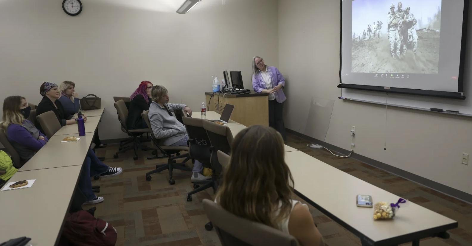 Weber State University students and staff listen and watch as photojournalist Lynsey Addario, who is currently covering the war in Ukraine for The New York Times, talks about her work during a video call at Elizabeth Hall in Ogden