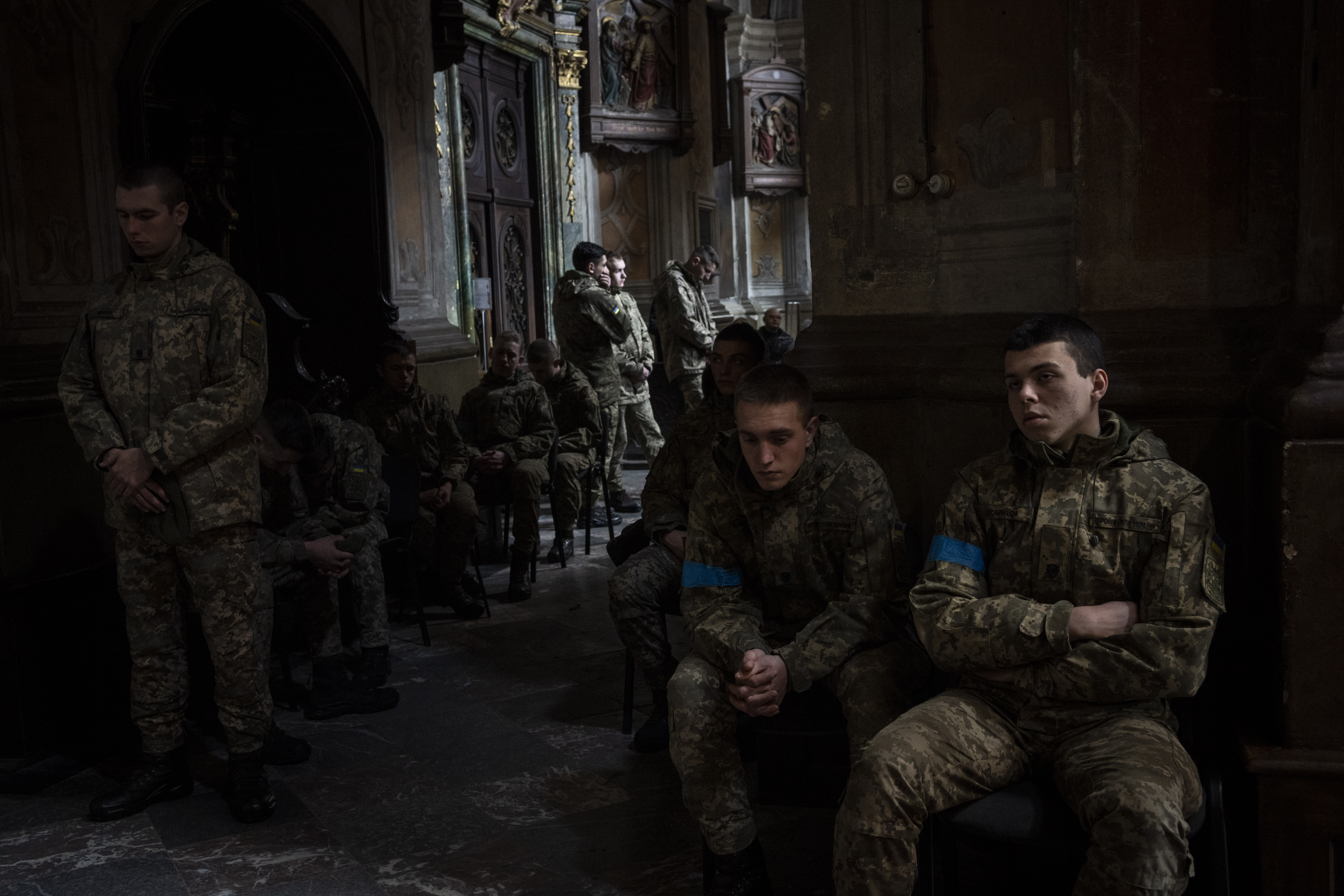 Military cadets attend a funeral ceremony for four of the Ukrainian military servicemen, who were killed during an airstrike in a military base in Yarokiv, in a church in Lviv, Ukraine, Tuesday.