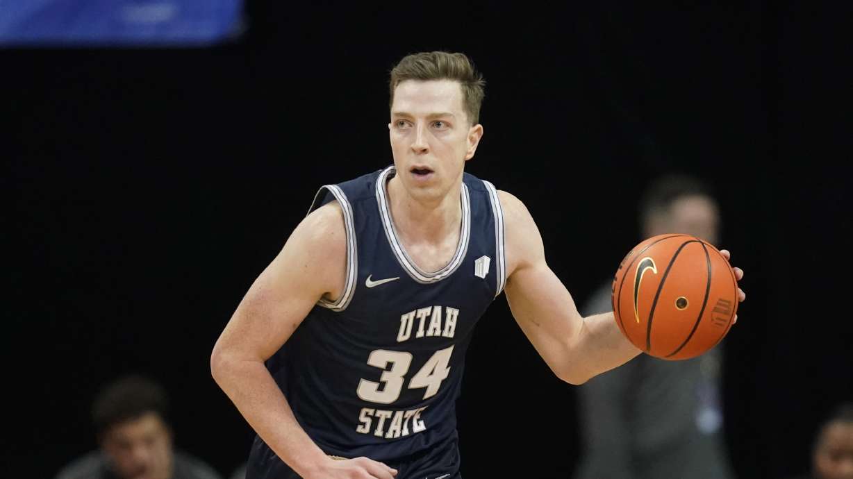 Utah State forward Justin Bean (34) brings the ball up court during the first half of an NCAA college basketball game against Colorado State in the quarterfinals of Mountain West Conference men's tournament Thursday, March 10, 2022, in Las Vegas.