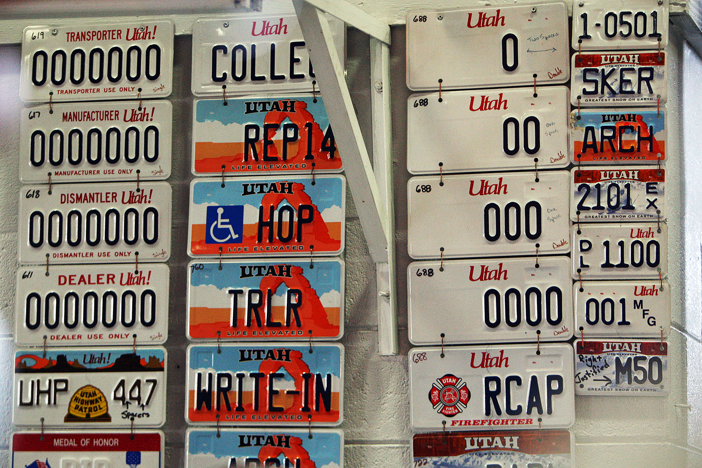 License plates on the wall in an area where the plates are manufactured at the Utah State Prison in Draper on March 5, 2014. The Utah Legislature passed a pair of bills this year designating new license plate designs.